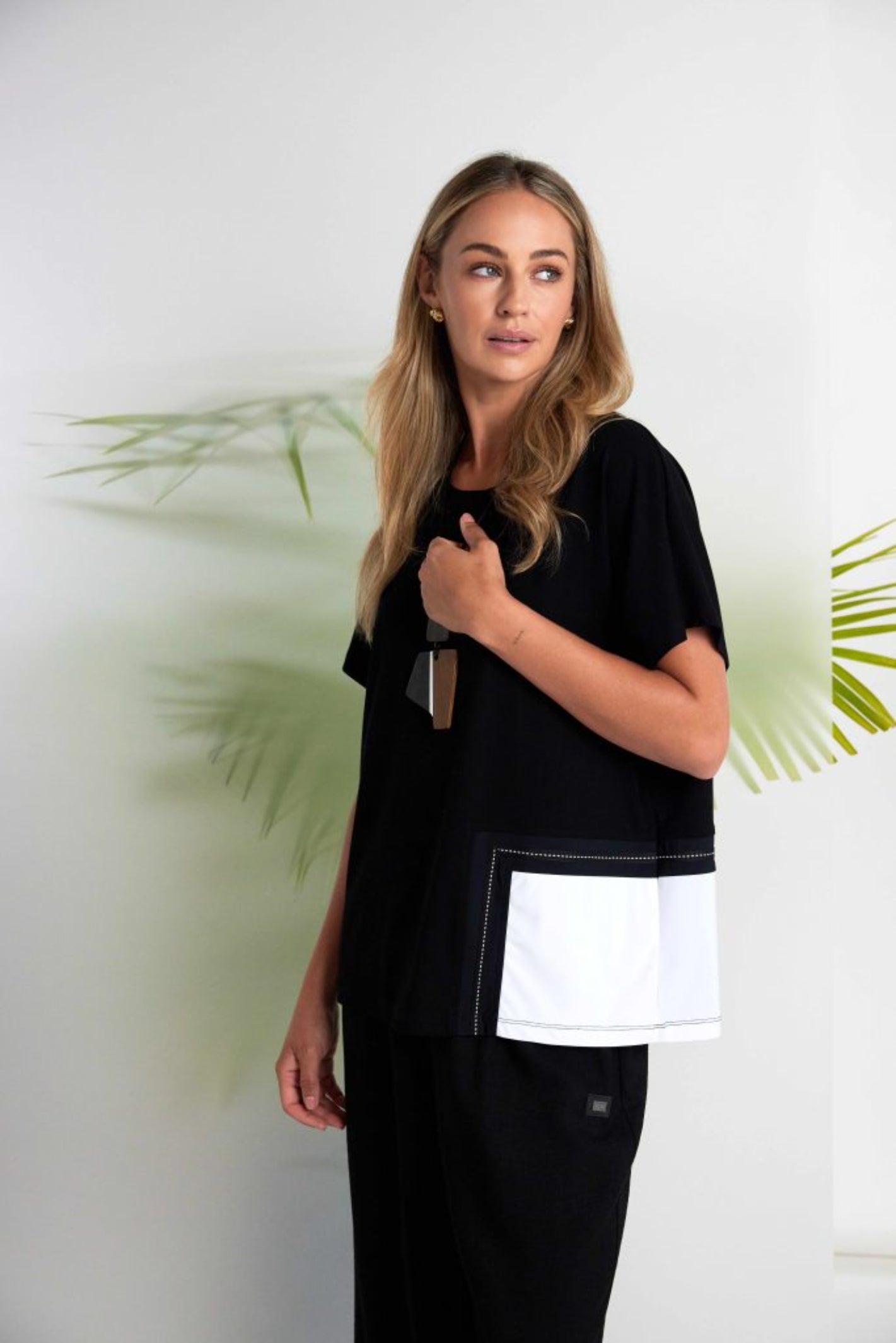 Model in Naya NAS26188 Round Neck Top with Contrast Pocket in Black & White by Naya, shop Naya at Dotique