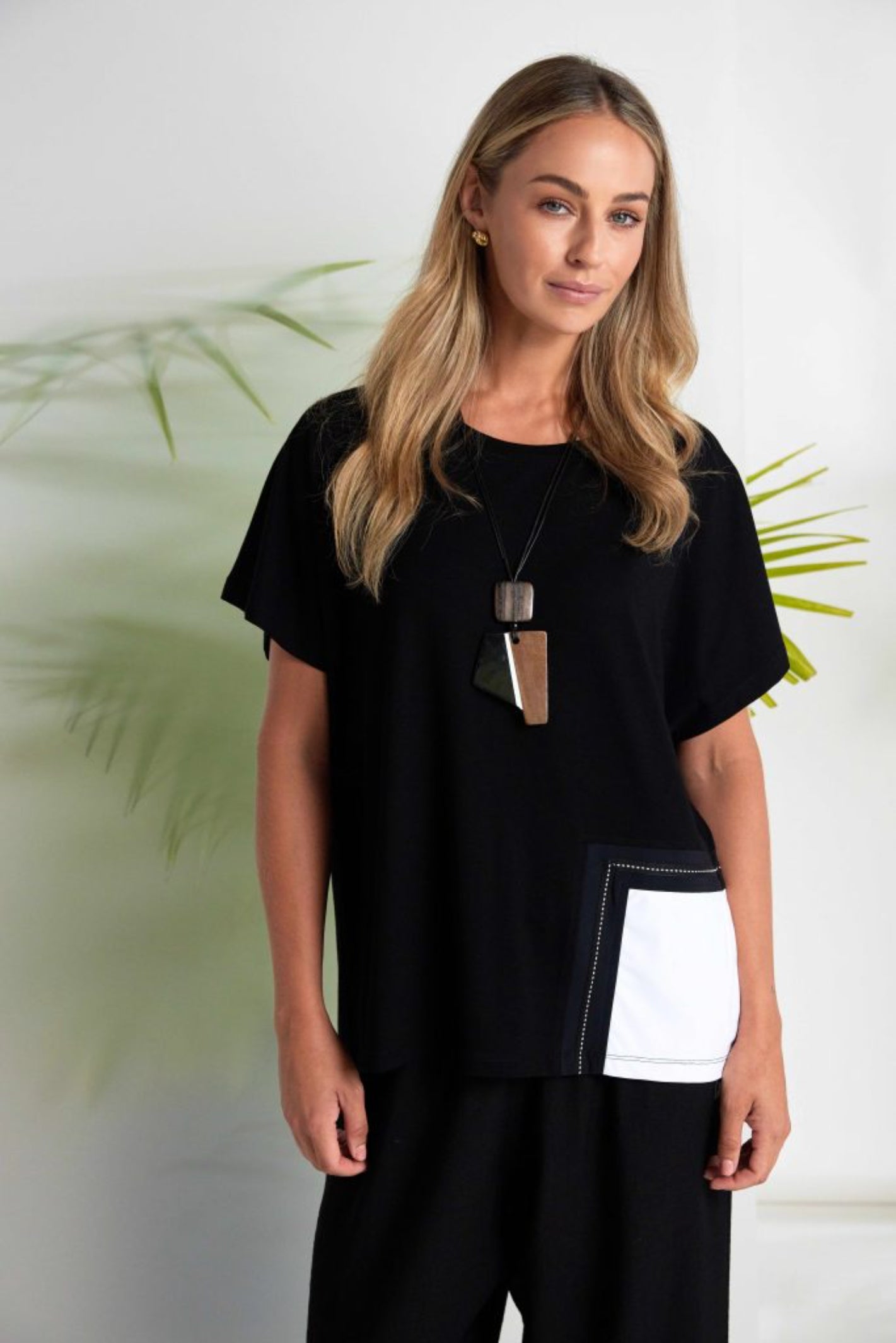 Woman wearing Naya NAS26188 Round Neck Top with Contrast Pocket in Black & White by Naya shop Dotique