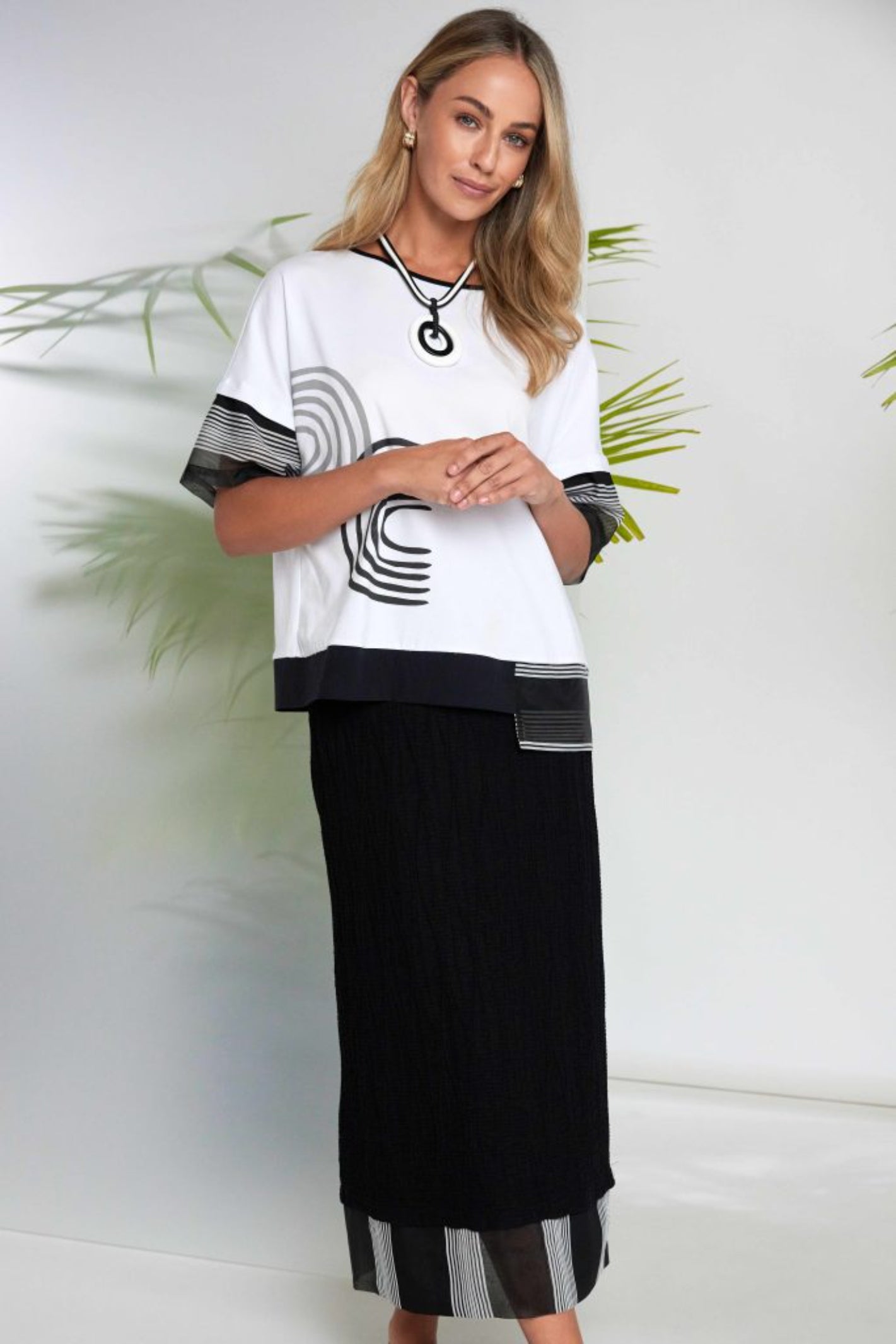 Naya NAS26259 White Black Print Top by Naya modeled with black skirt, shop Naya styles at Dotique online store.