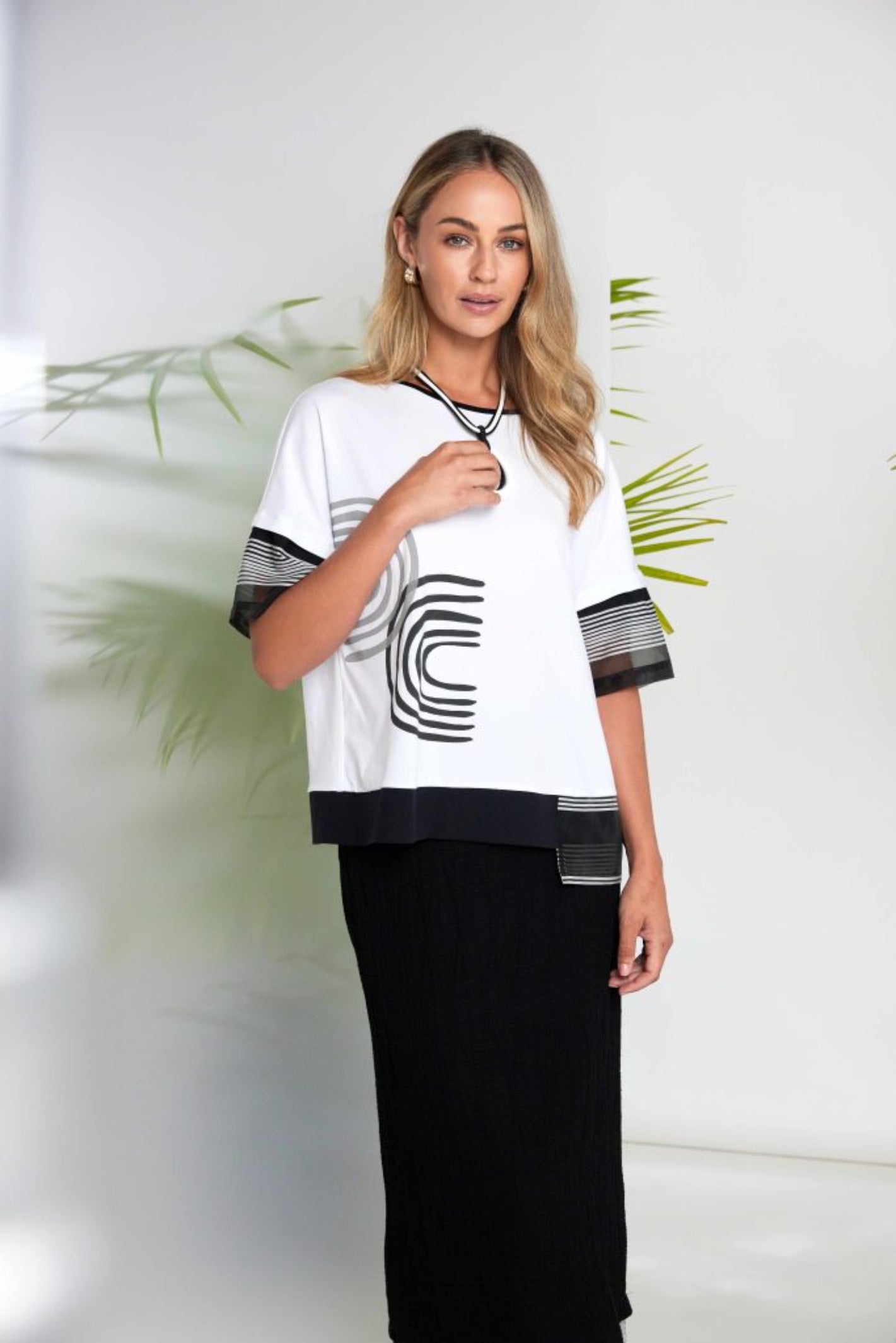 Model wearing Naya NAS26258 Embossed Pull-On Midi Skirt with Stripe Hem by Naya shop the vendor at Dotique