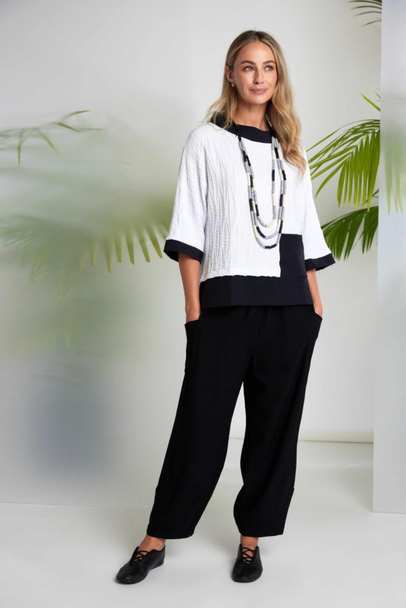 Model wearing Naya NAS26264 White Black Embossed Jacquard Top by Naya, shop this elegant design at Dotique