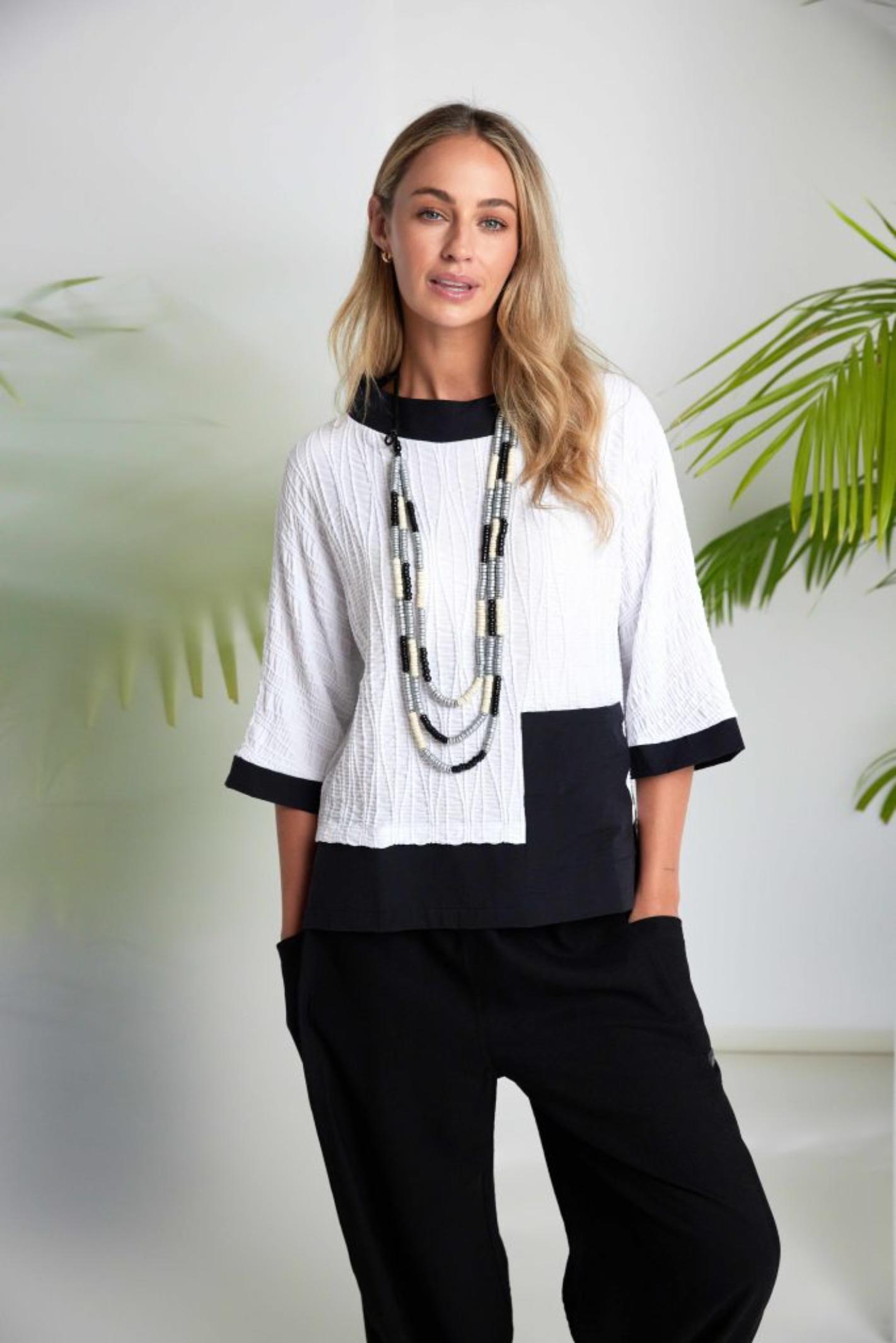 Model wearing Naya NAS26264 White Black Embossed Jacquard Top from Naya available to shop at Dotique
