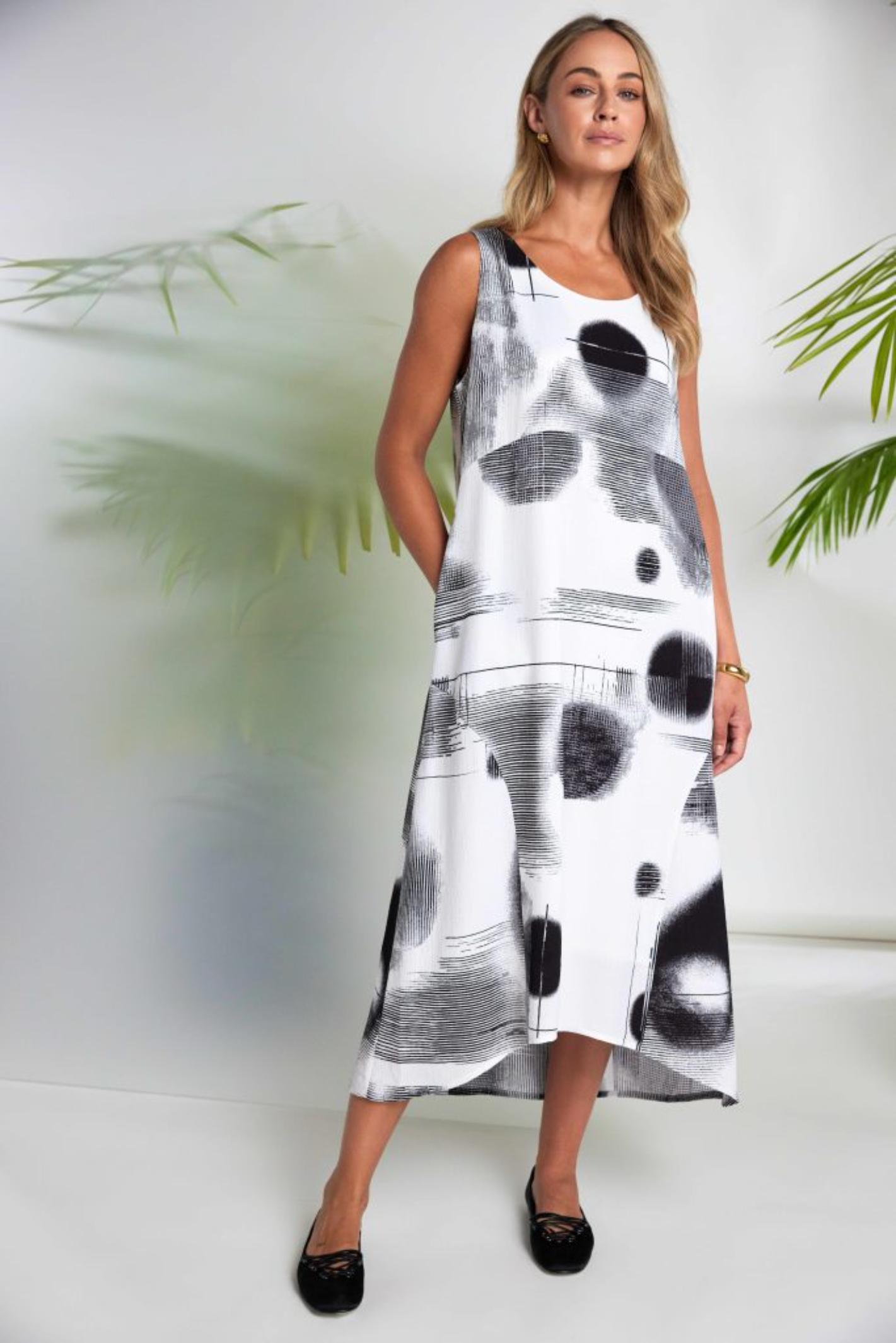 Model wearing Naya NAS26312 Blurred Spot Print Sleeveless Dress – White & Black, shop Naya at Dotique online.