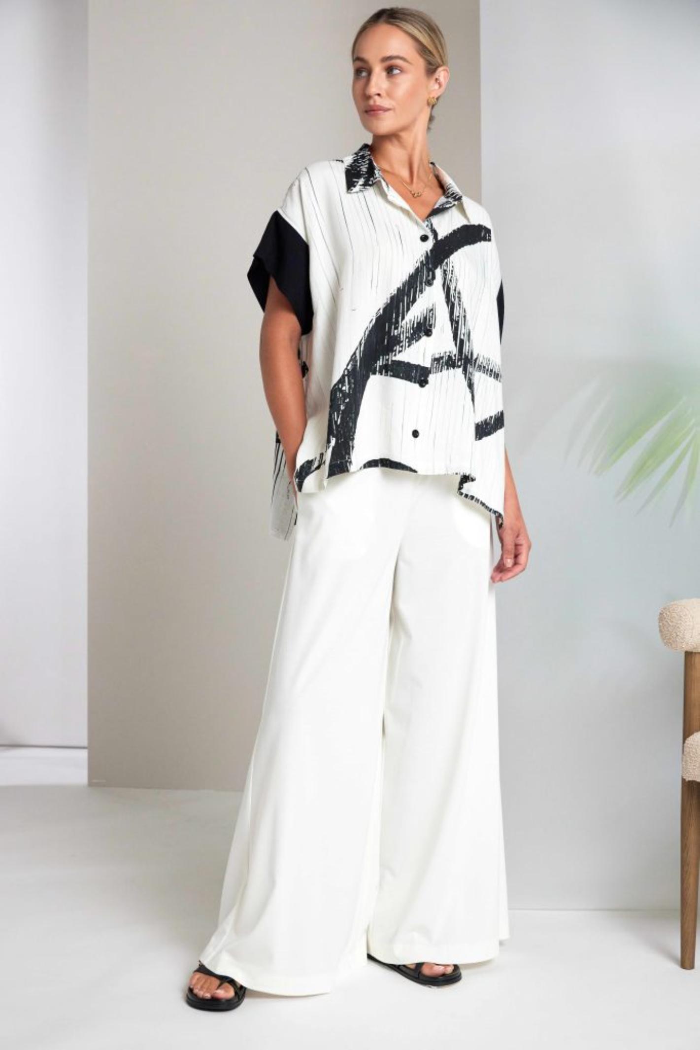 Model wearing Naya NAS26318 Brush Stroke Print Blouse with Contrast Cuff – Cream & Black Shop Naya at Dotique fashion retailer