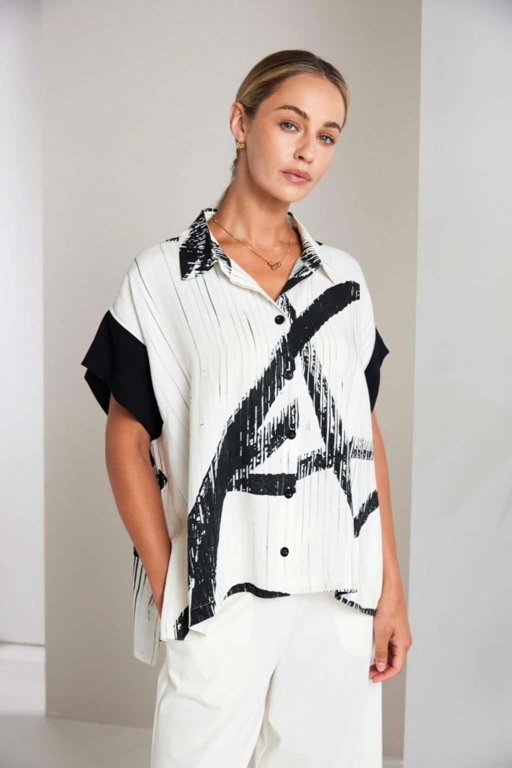 Model wearing Naya NAS26318 Brush Stroke Print Blouse with Contrast Cuff – Cream & Black by Naya shop at Dotique.
