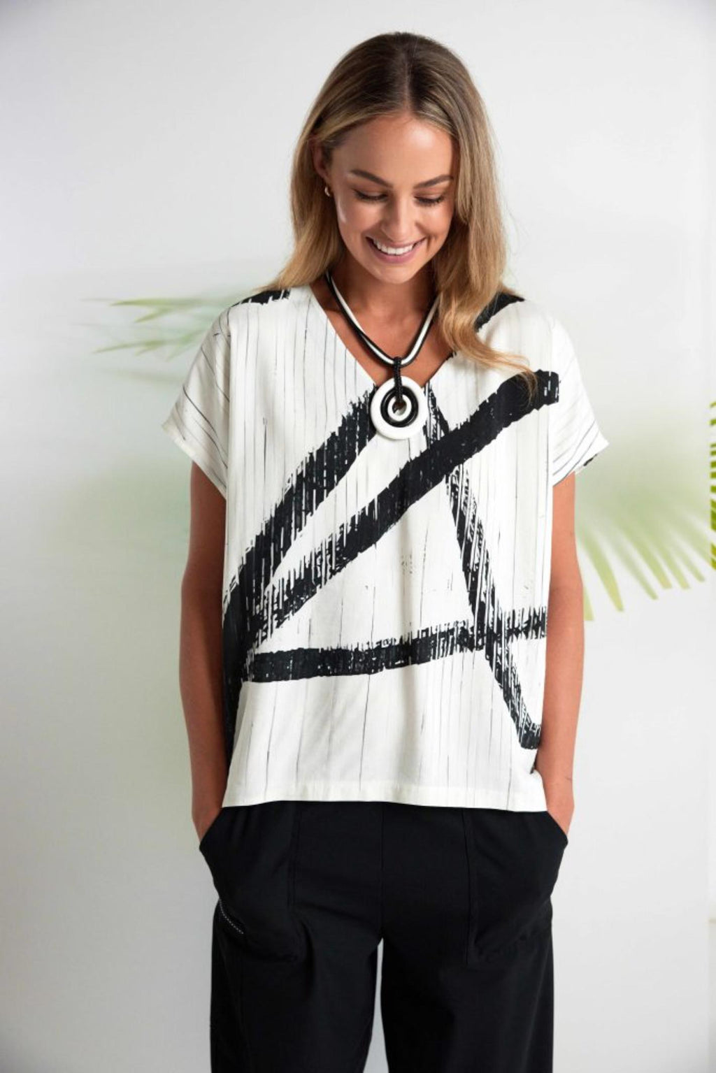 Woman wearing Naya NAS26319 Cream Black Brush Stroke V-Neck Top by Naya, shop Naya at Dotique