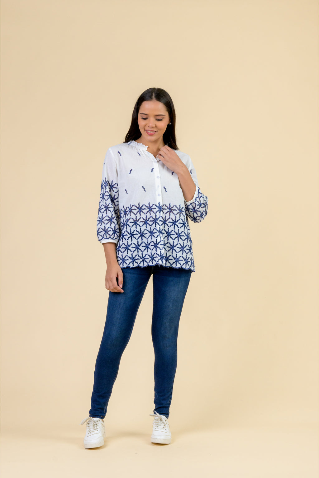 Handprint Dream Apparel NE7111 Eris Top White Navy with blue geometric patterns on sleeves and hem, worn by model. Shop Handprint Dream Apparel at Dotique.