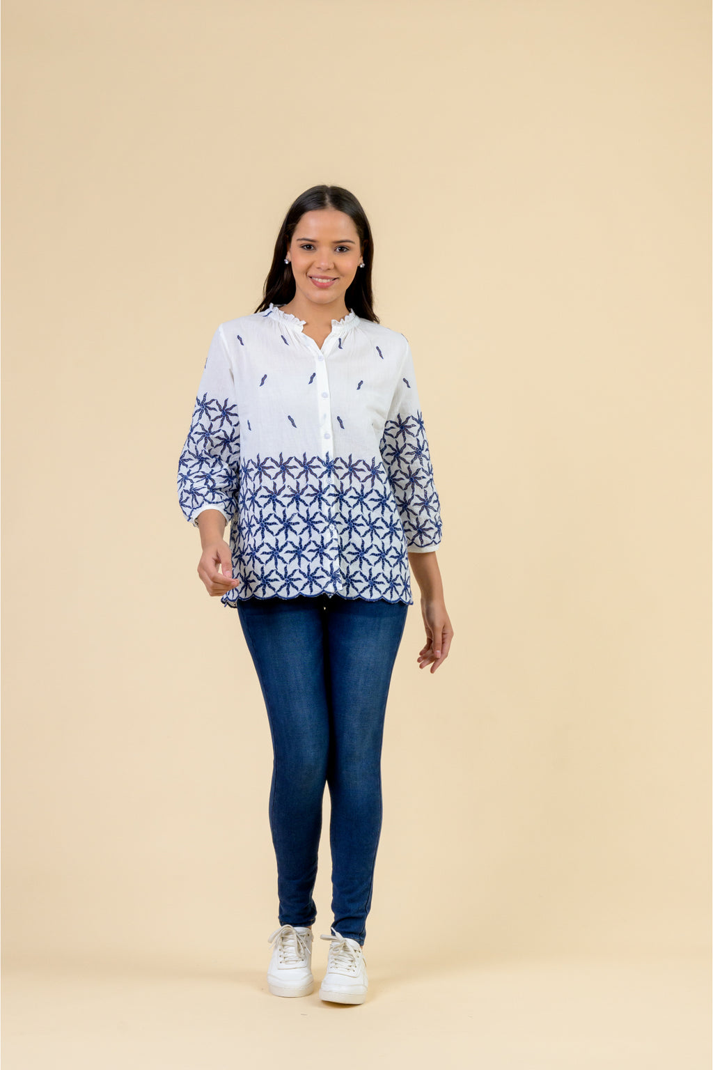 Handprint Dream Apparel NE7111 Eris Top White Navy featuring a white blouse with navy floral embroidery, worn by model. Shop Handprint Dream Apparel at Dotique.