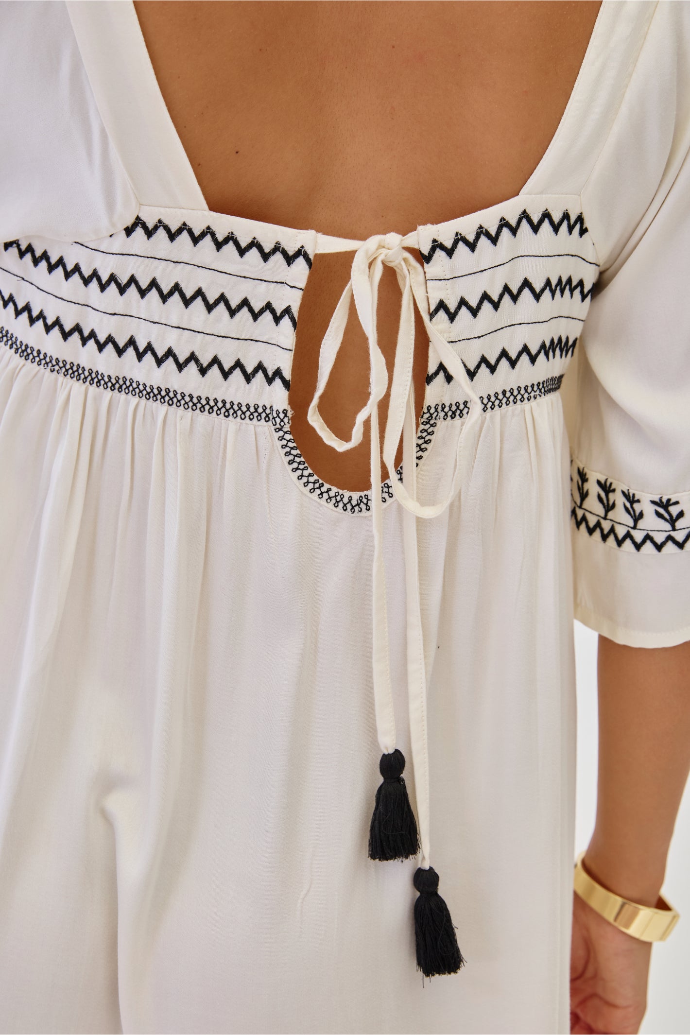 Back detail of NKN Nekane Jelani White Short Viscose Dress with 3/4 Sleeves and Bicolour Embroidery by nkn nekane, shop at Dotique