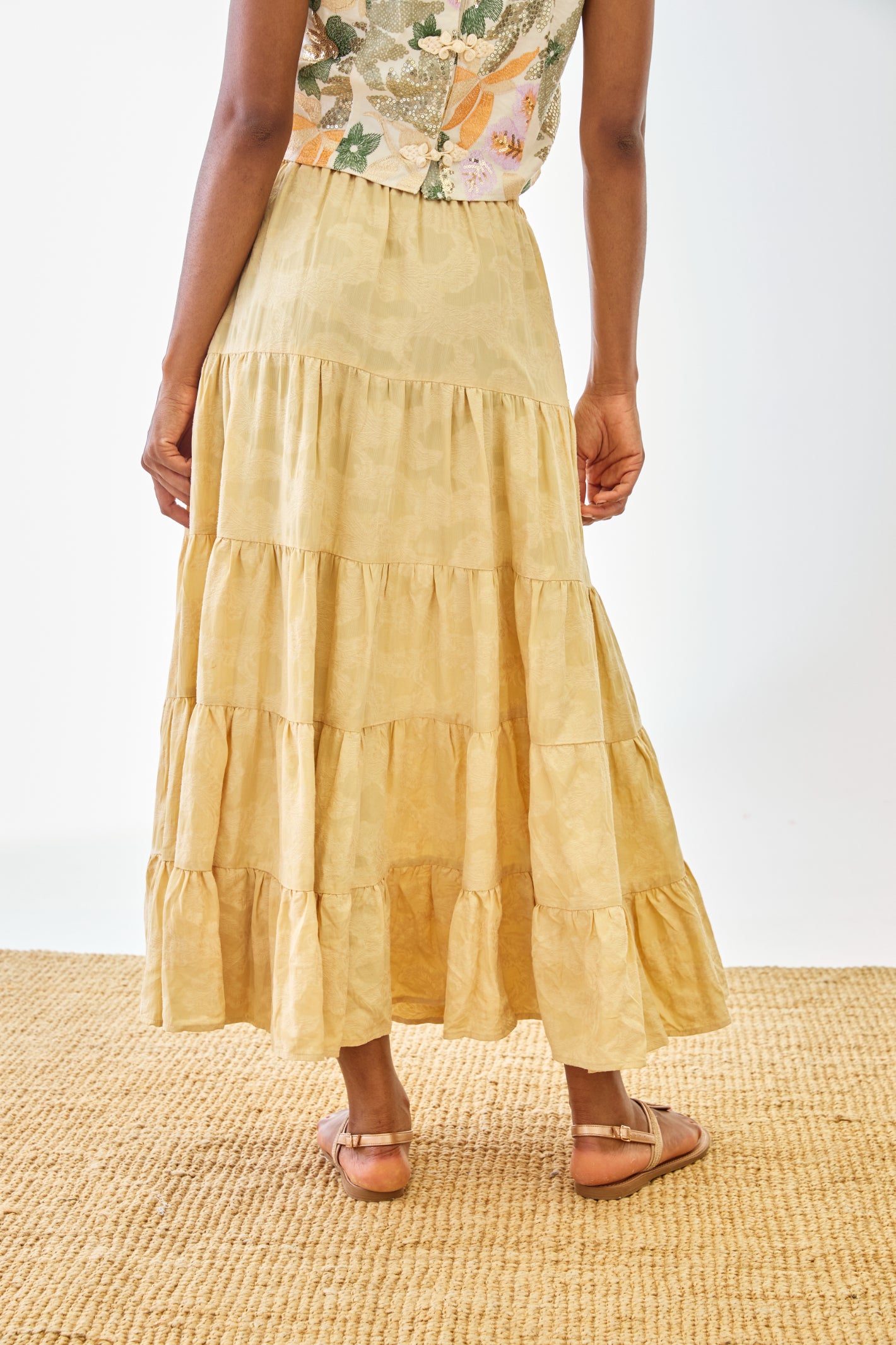 Rear view of model wearing NKN Nekane Riloru Yellow Long Linen Ruffled Skirt by nkn nekane, shop nkn nekane at Dotique