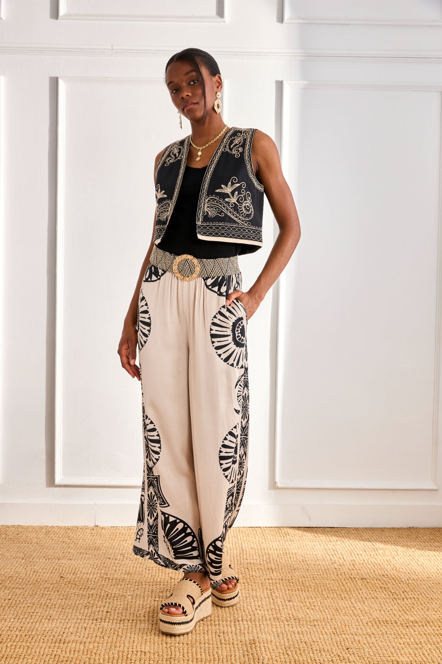 Model wearing NKN Nekane Adanna White Geometric Print Trousers by nkn nekane, shop nkn nekane at Dotique
