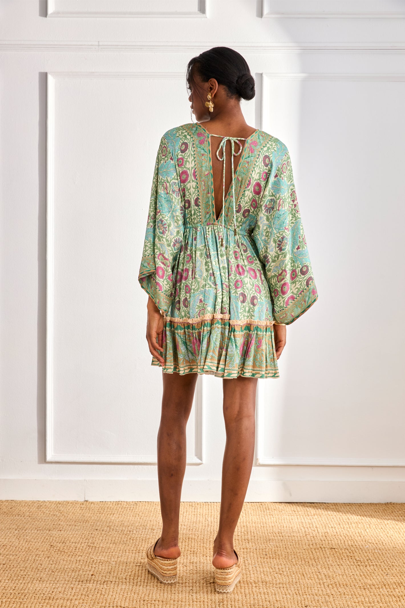Rear view of model wearing NKN Nekane Gaia Aqua Short Viscose Dress with Botanical Print and Japanese Sleeves by nkn nekane, shop Dotique