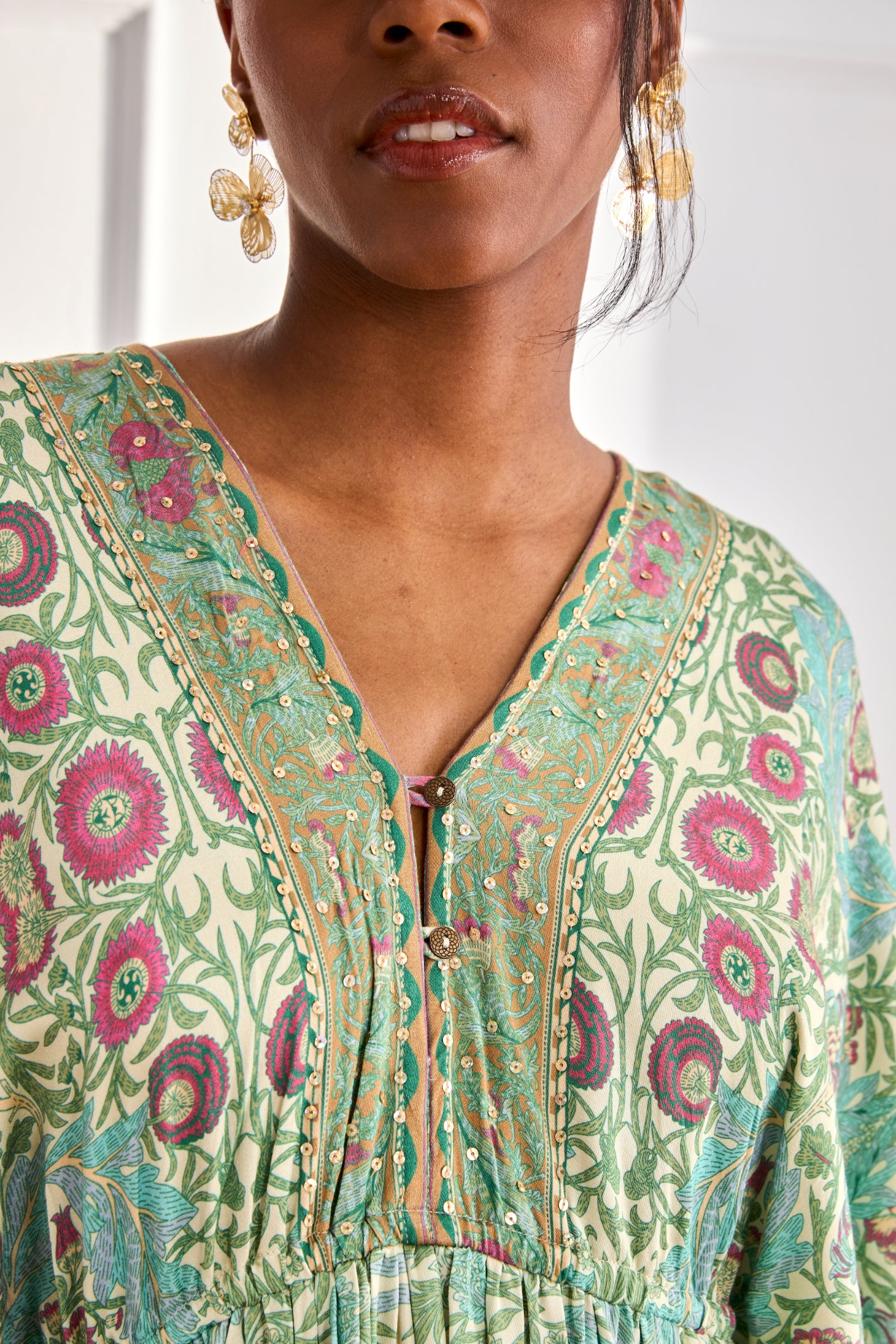 Close-up of neckline on NKN Nekane Gaia Aqua Short Viscose Dress with Botanical Print and Japanese Sleeves by nkn nekane, shop Dotique