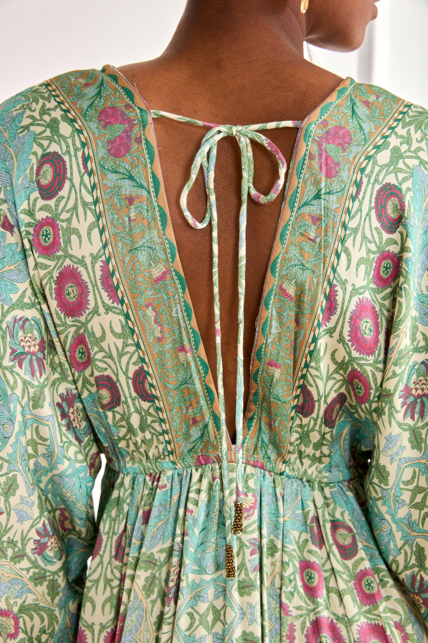 Back view of NKN Nekane Gaia Aqua Short Viscose Dress with Botanical Print and Japanese Sleeves, shop nkn nekane at Dotique