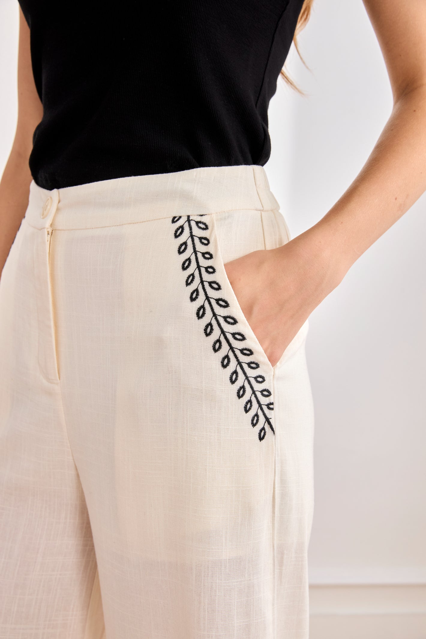 Close-up of pocket embroidery on NKN Nekane Arsi Ivory Linen Trousers with Embroidery on Hem and Pocket by nkn nekane shop Dotique