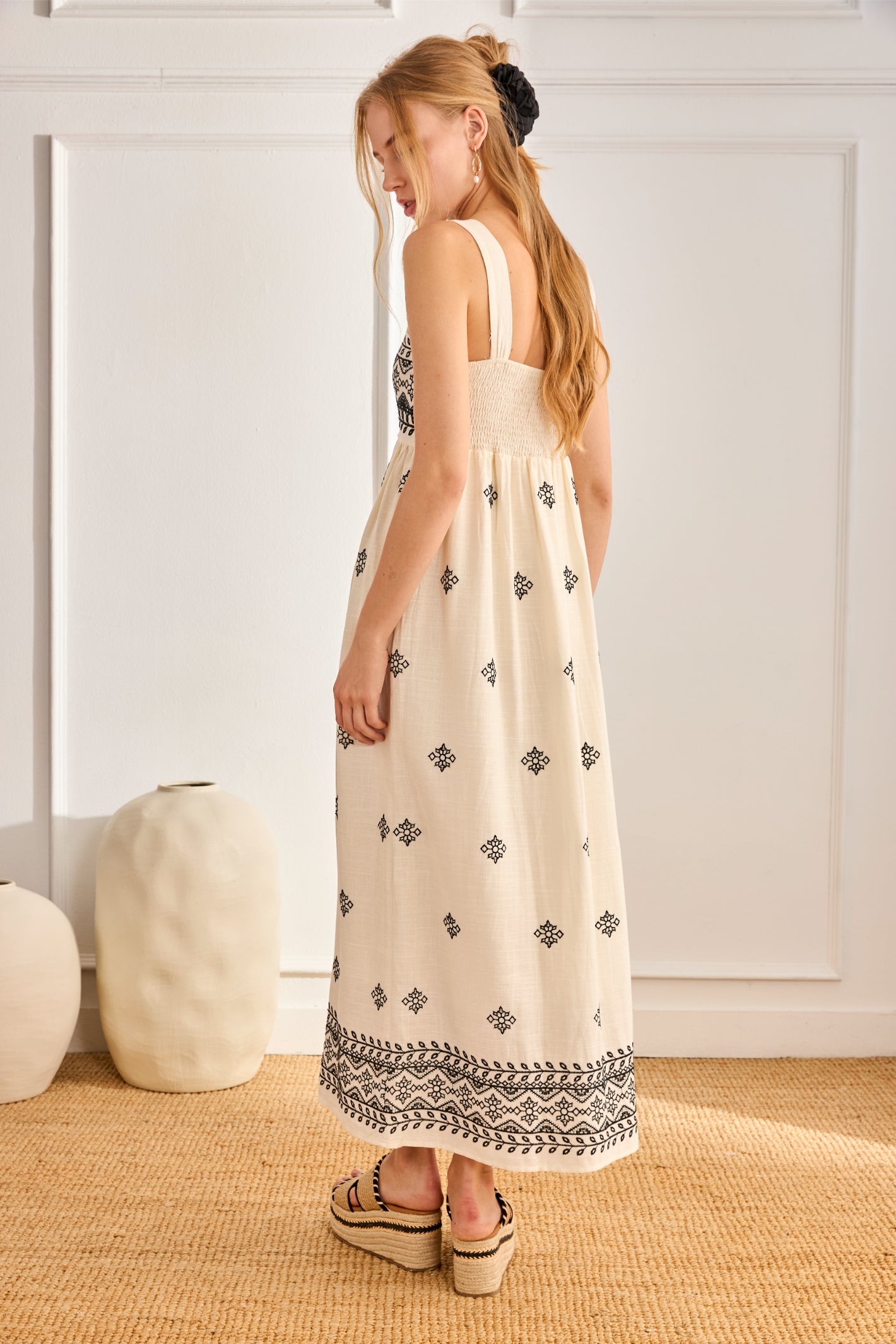 Side view of model in NKN Nekane Urani Ivory Long Linen Dress with Embroidery and Square Neckline, shop nkn nekane at Dotique