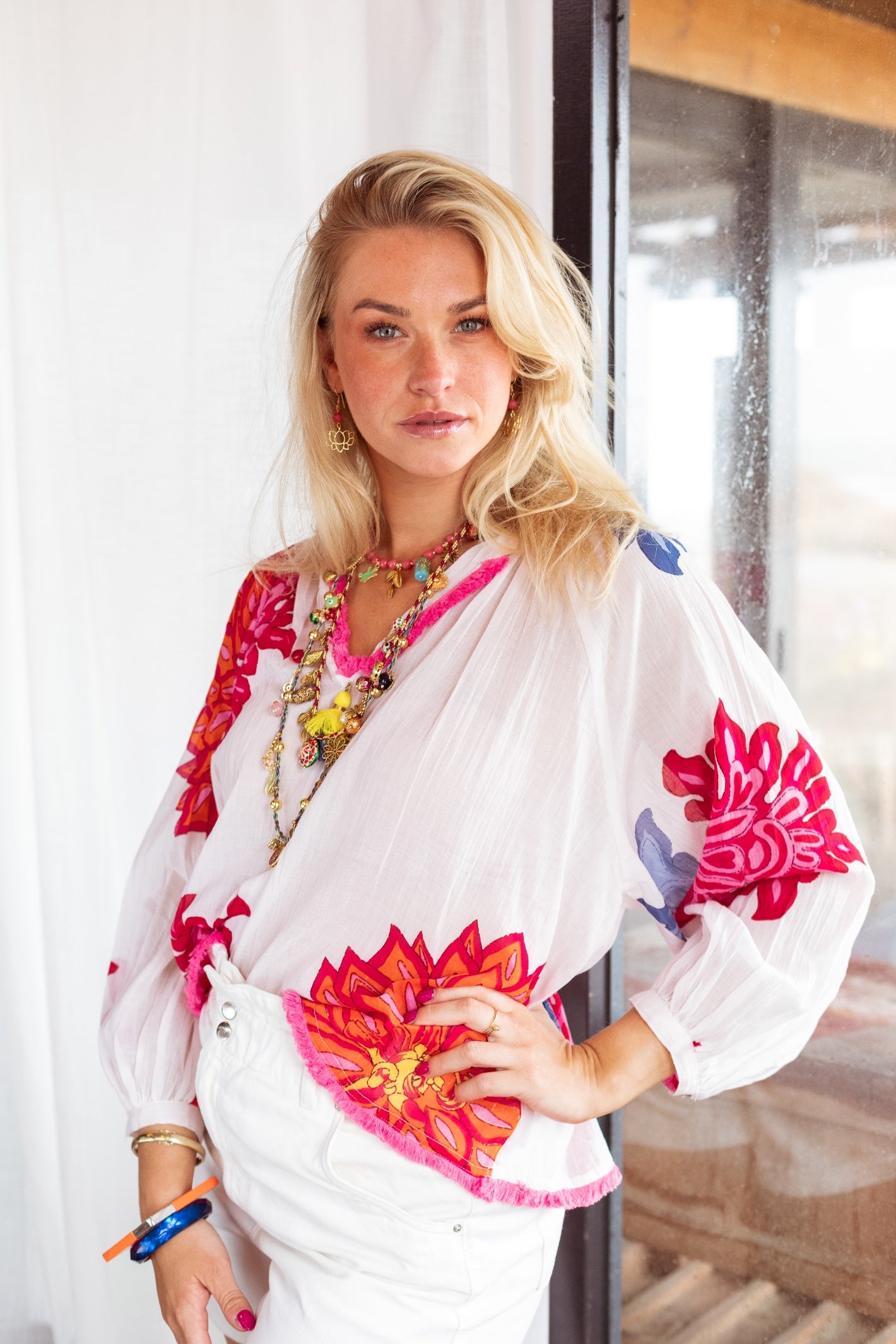 Model wearing Place Du Soleil White Blouse With Large Flower Print Long Sleeves S26-425 by Place du Soleil, shop Place du Soleil at Dotique
