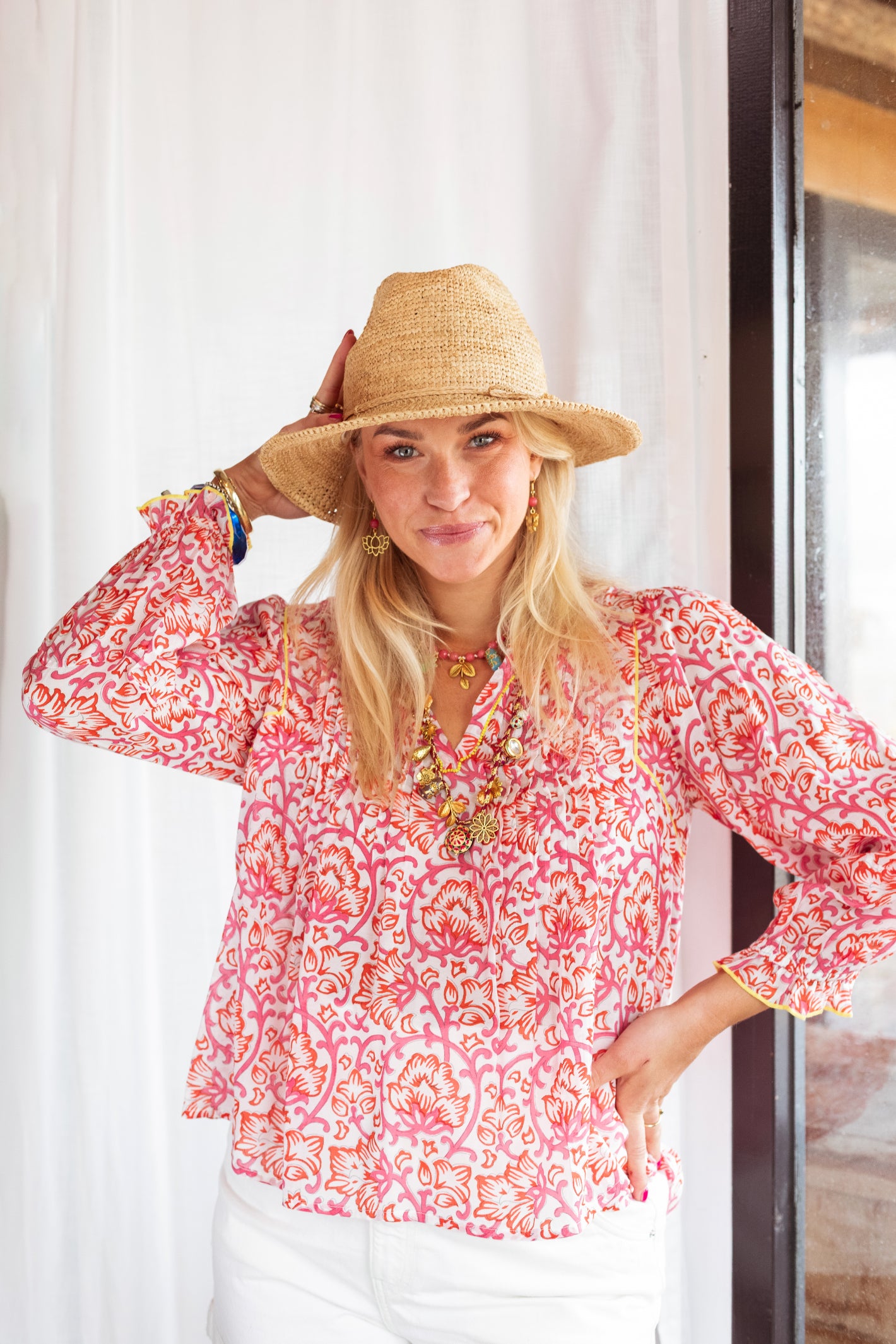 Model wearing Place Du Soleil Red Rosa Print Blouse S26-328 by Place du Soleil, shop Place du Soleil at Dotique for vibrant style