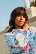 Close-up of a woman wearing Numph 706787 Nusurfer Gingham Embroidered Shirt Placid Blue with colorful marine embroidery by Numph. Shop Numph at Dotique.