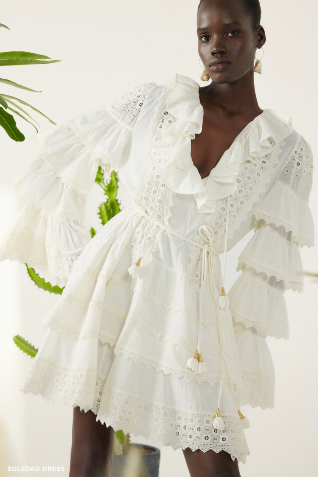 Model wearing Scarlett Poppies Soledad Dress Simply White featuring lace detailing and tiered ruffle sleeves, shop Scarlett Poppies at Dotique.