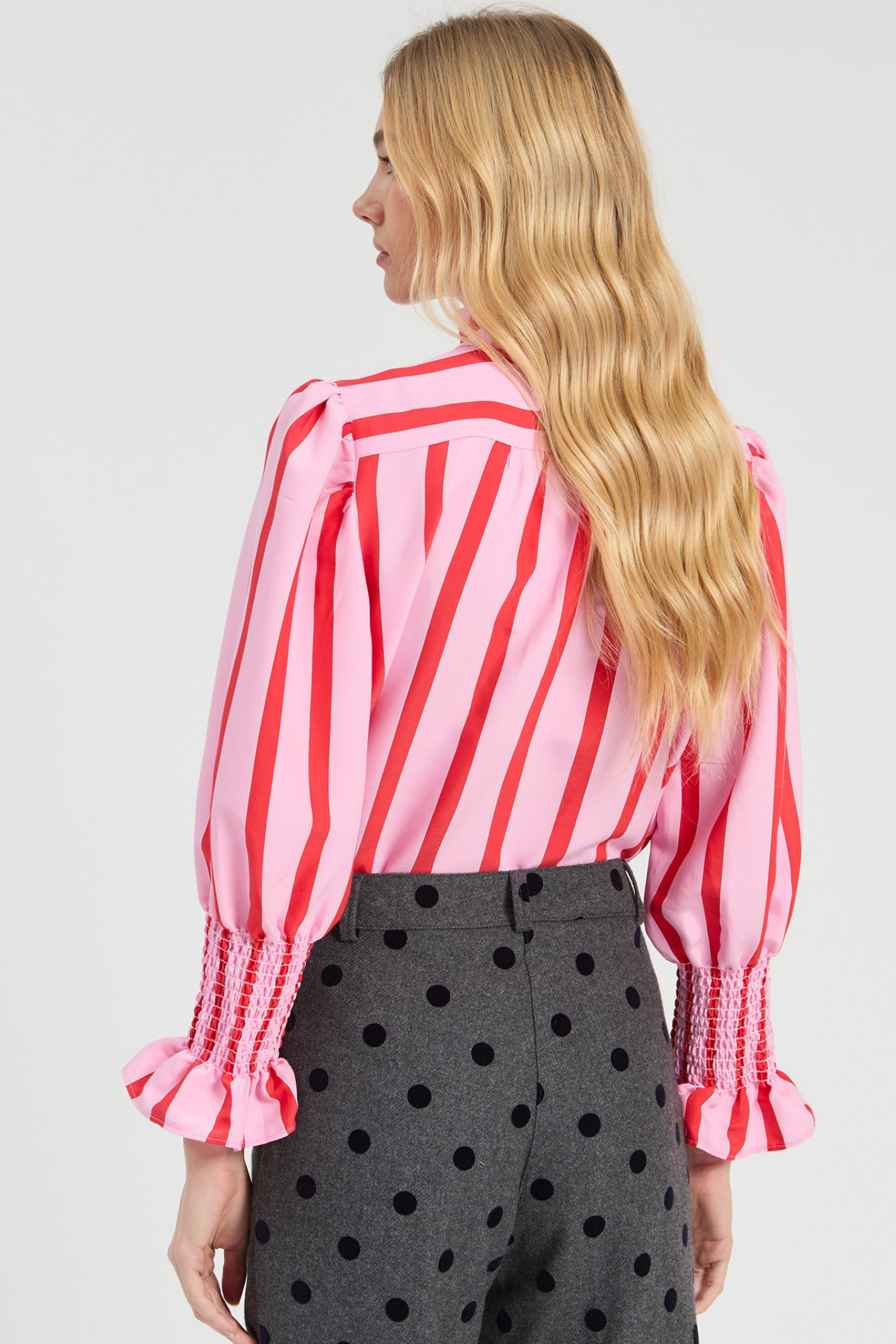 Shop the Vilagallo Pink & Red Striped Ruffle Shirt at Dotique. Made from a lightweight viscose blend with a frilled neckline, shirred cuffs and bold striped design.