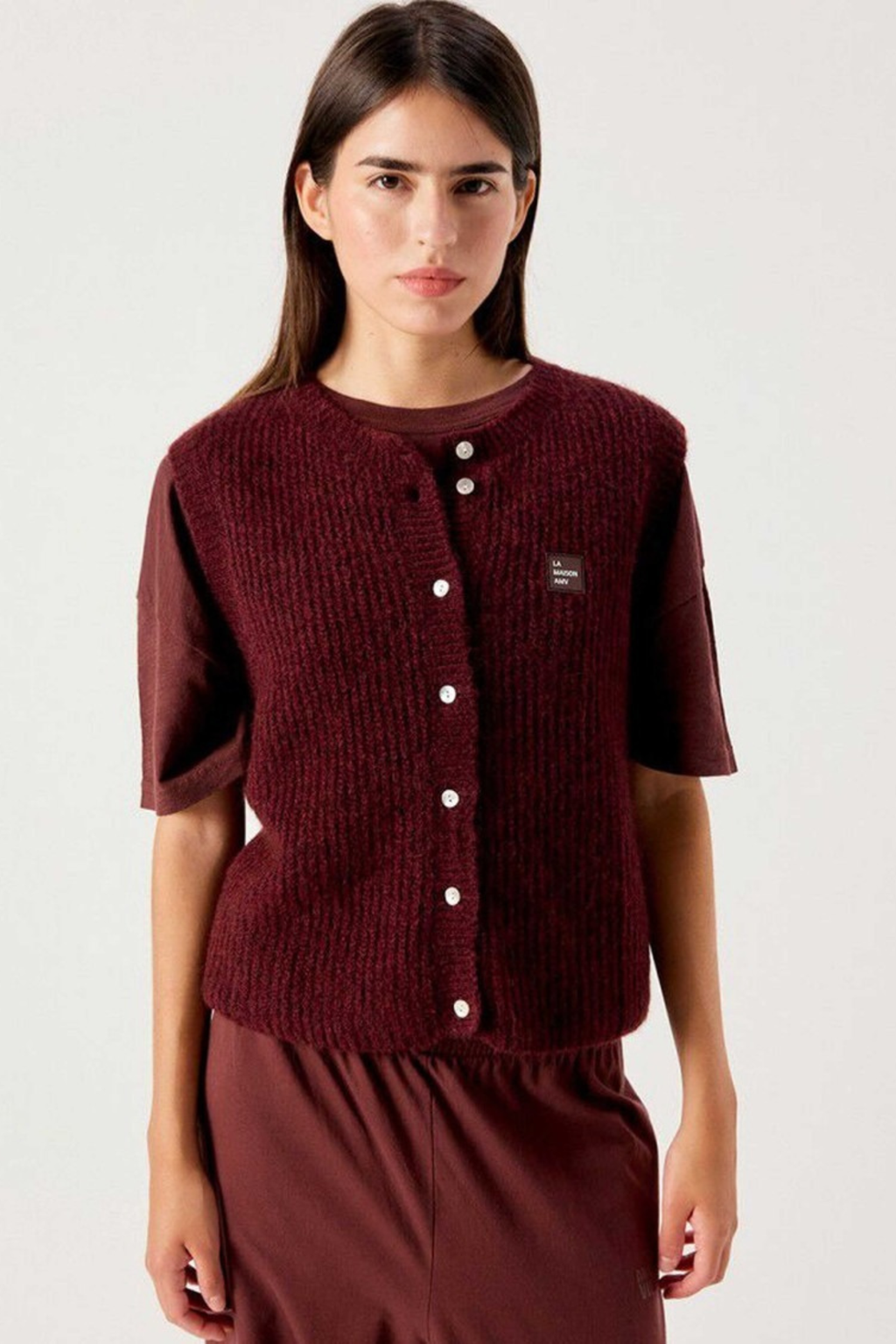 Shop the American Vintage East Knitted Waistcoat in Acerola Chine at Dotique. A soft alpaca blend knitted waistcoat with a relaxed fit, button front and rich burgundy melange colour.