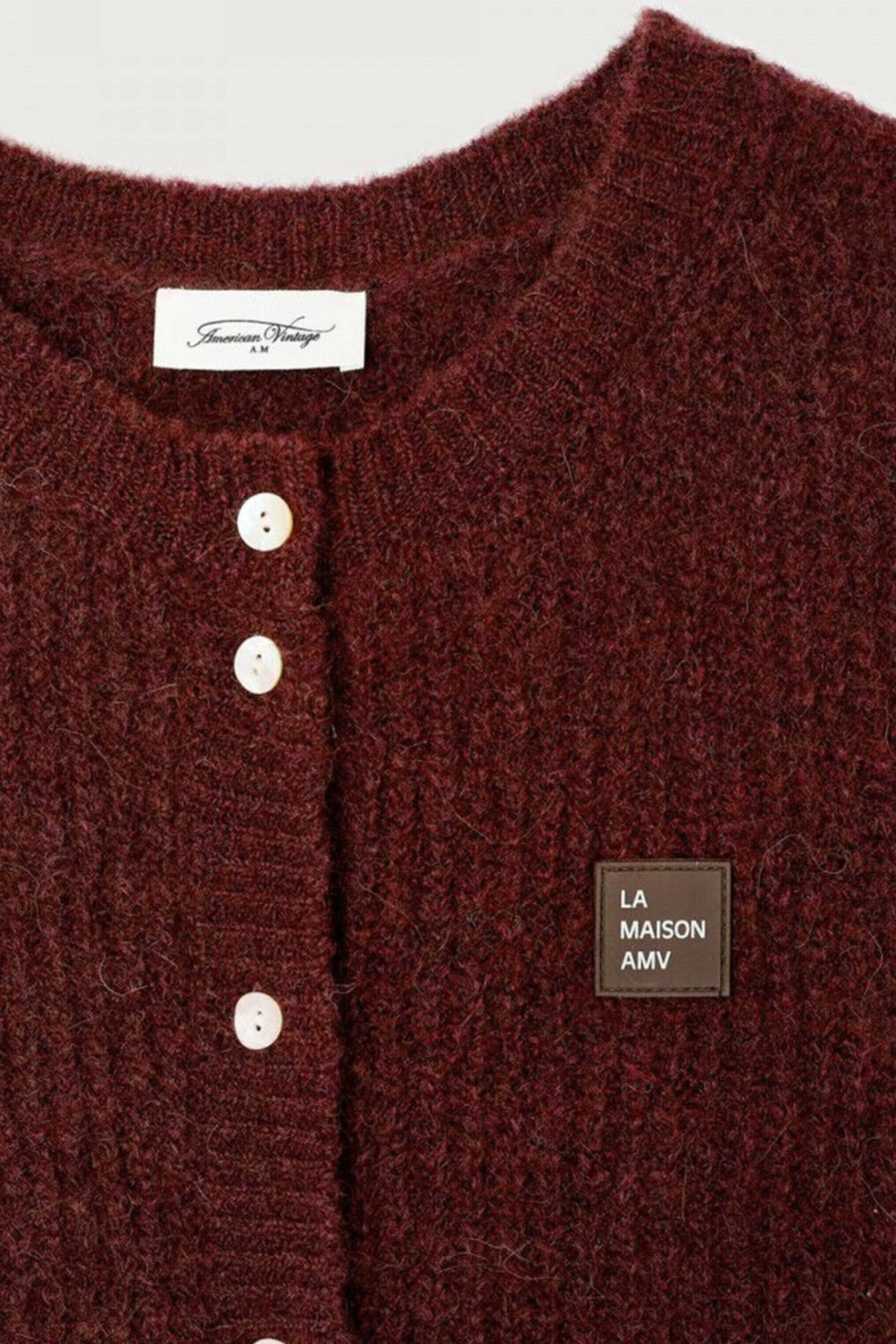 Shop the American Vintage East Knitted Waistcoat in Acerola Chine at Dotique. A soft alpaca blend knitted waistcoat with a relaxed fit, button front and rich burgundy melange colour.