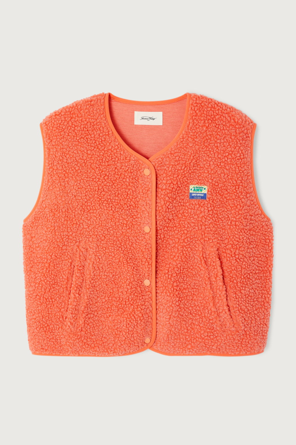 Shop the American Vintage Hoktown Sleeveless Fleece Gilet in Sunset Chine at Dotique. A cosy recycled fleece layering piece in a vibrant coral orange with a relaxed fit.