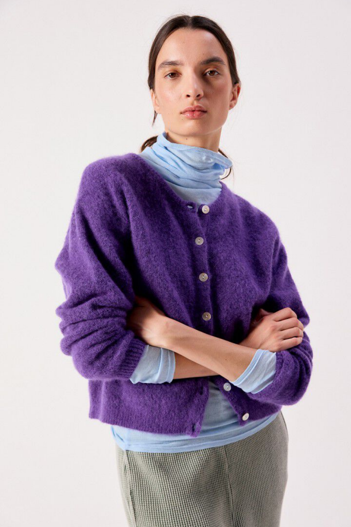 American Vintage Women's Vitow Cardigan Cosmos in purple worn with a blue scarf. Shop American Vintage at Dotique