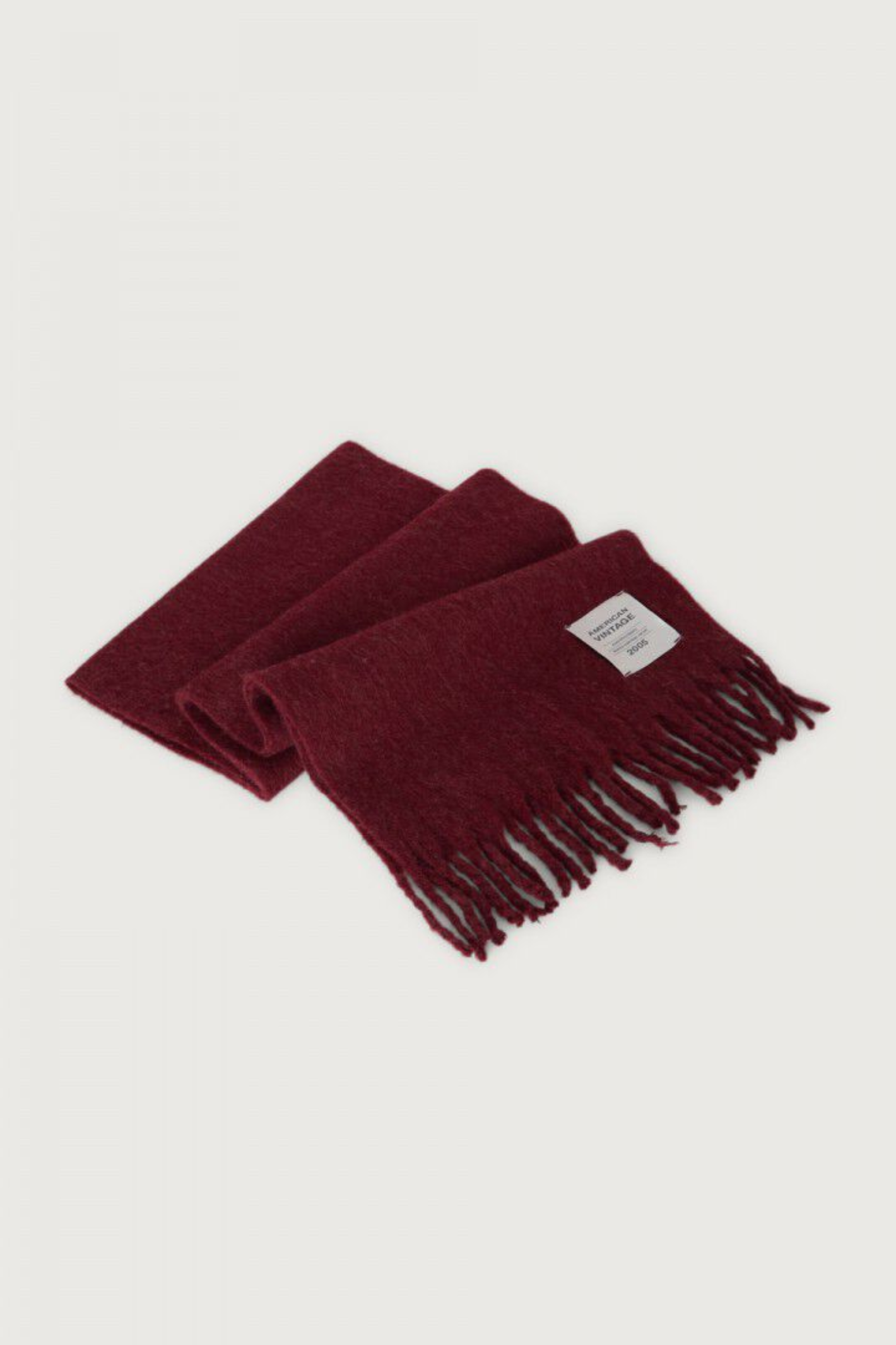 Shop the American Vintage Zinaco Scarf in Cherry Tree Logo at Dotique. A soft brushed scarf with fringed edges in a rich burgundy shade for effortless everyday styling.