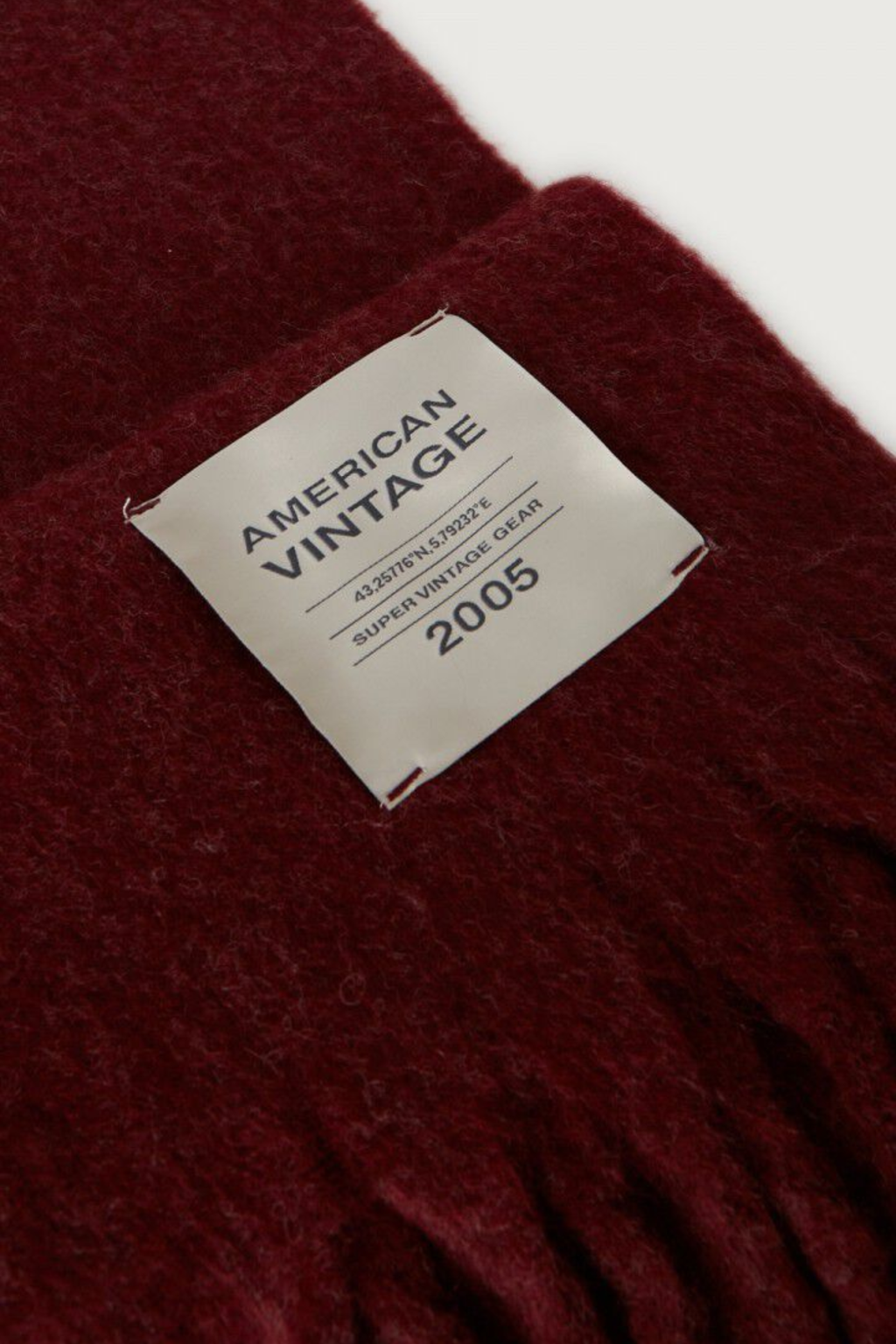 Shop the American Vintage Zinaco Scarf in Cherry Tree Logo at Dotique. A soft brushed scarf with fringed edges in a rich burgundy shade for effortless everyday styling.