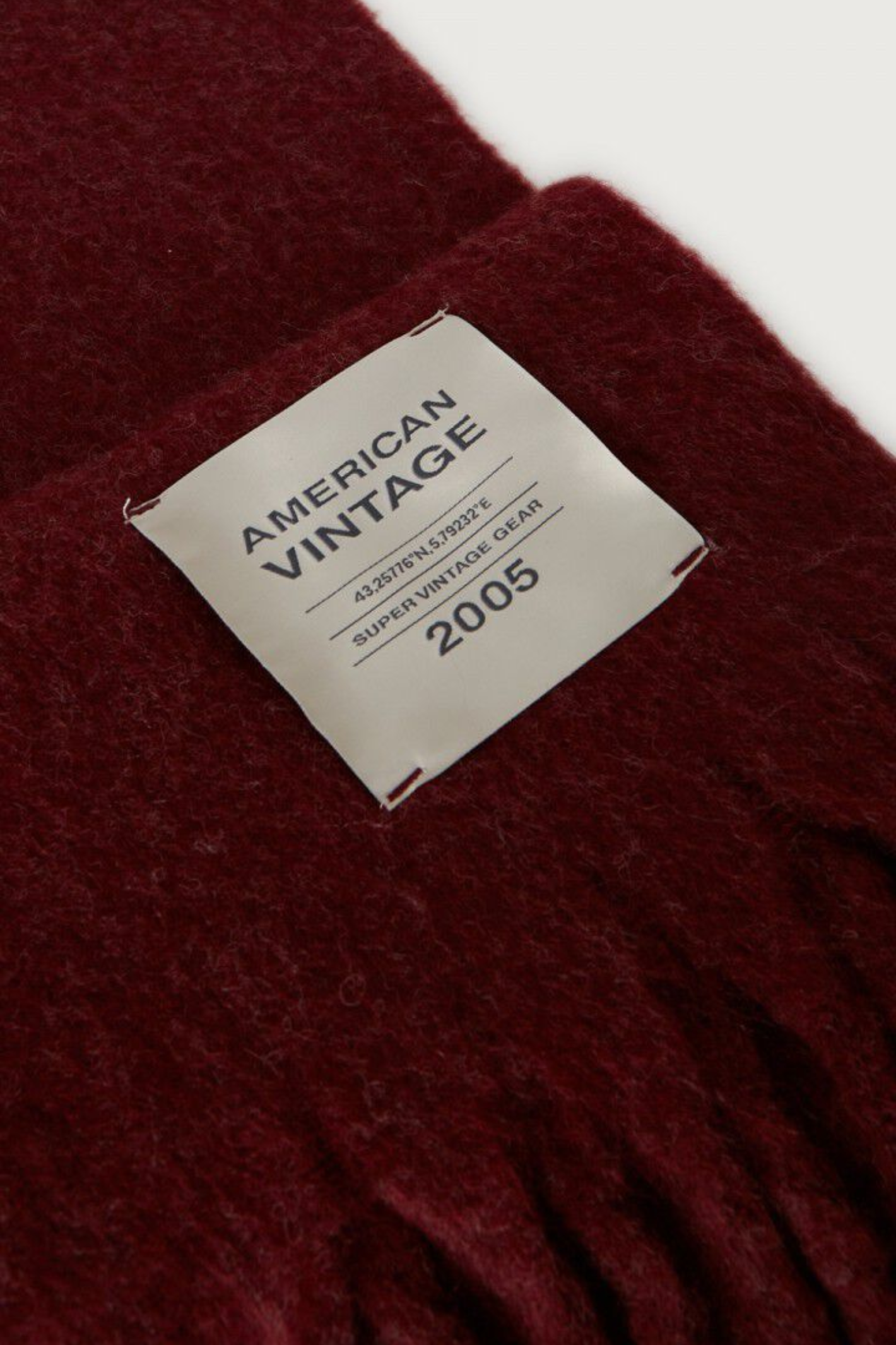 Shop the American Vintage Zinaco Scarf in Cherry Tree Logo at Dotique. A soft brushed scarf with fringed edges in a rich burgundy shade for effortless everyday styling.