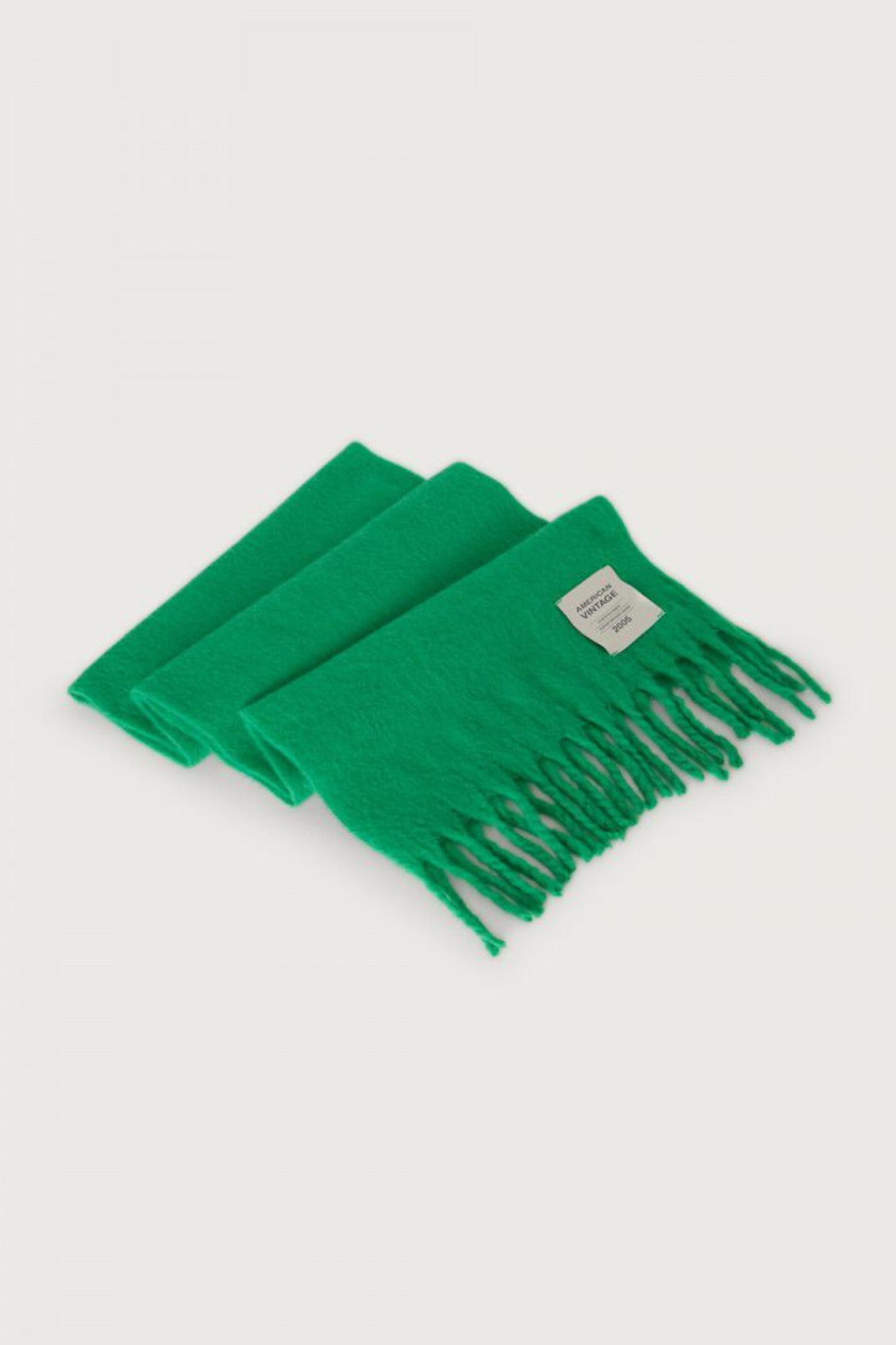 Shop the American Vintage Zinaco Scarf in Mint at Dotique. A soft brushed scarf with fringed edges in a vibrant green shade for effortless everyday styling.