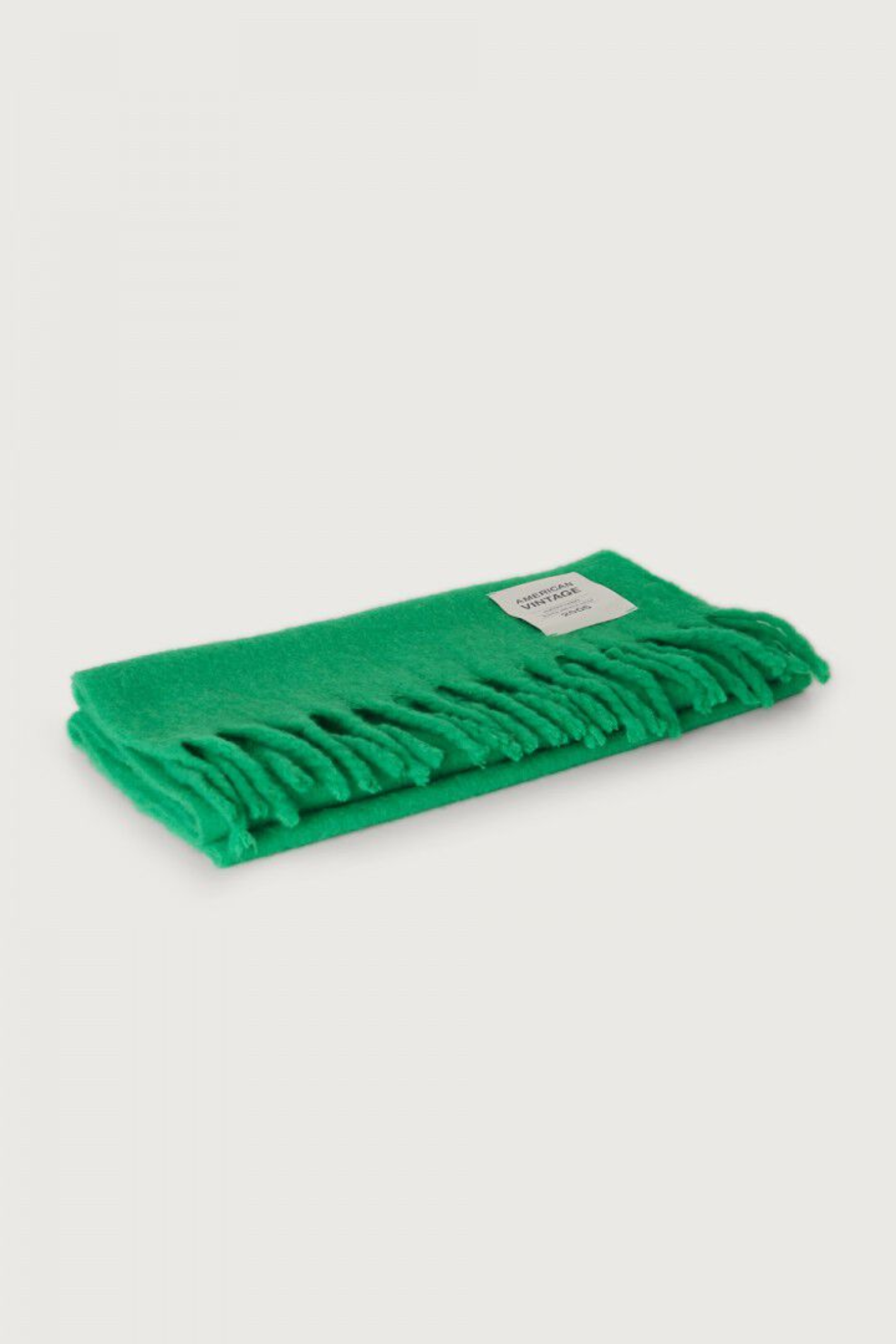 Shop the American Vintage Zinaco Scarf in Mint at Dotique. A soft brushed scarf with fringed edges in a vibrant green shade for effortless everyday styling.