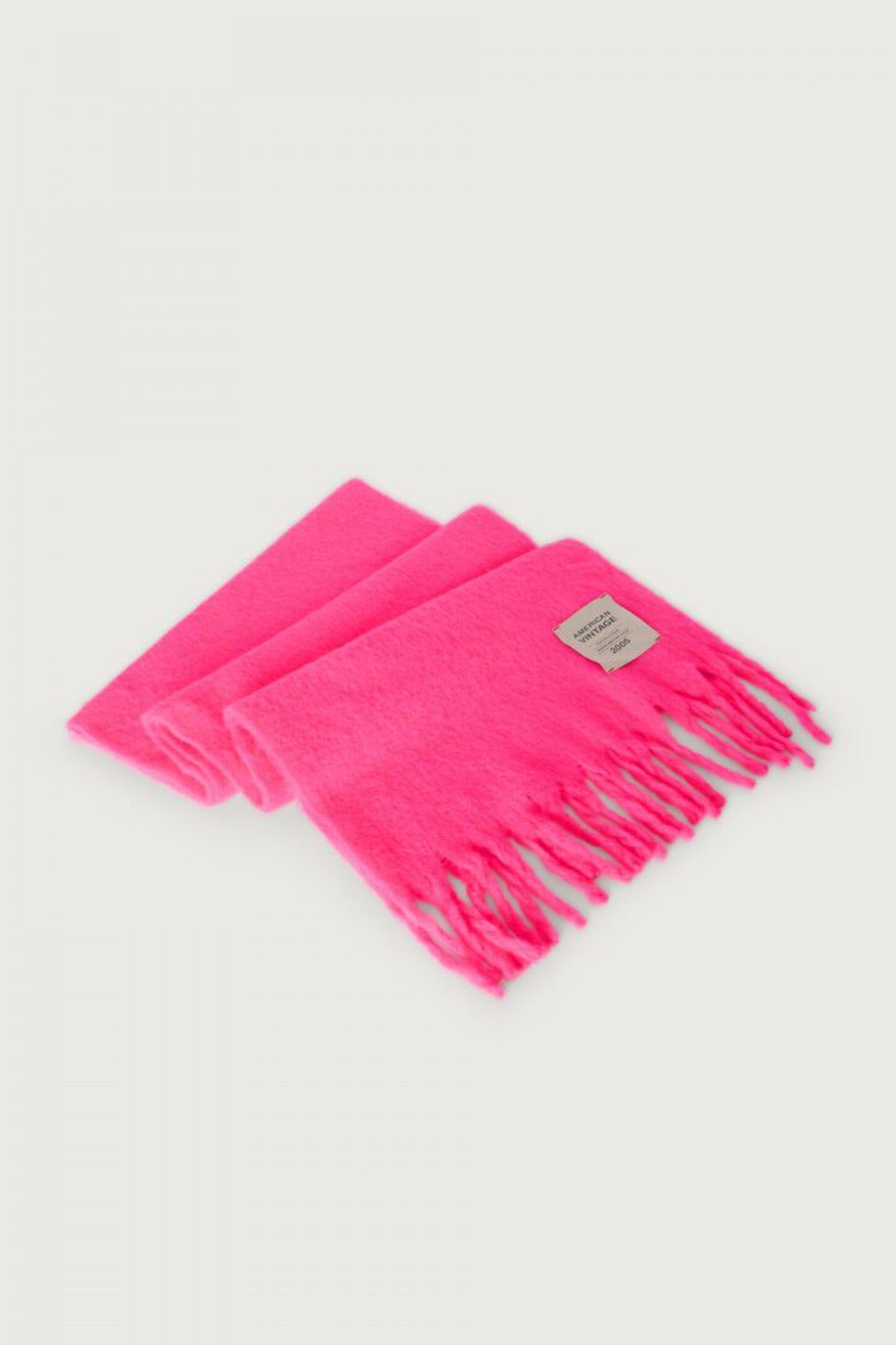 Shop the American Vintage Zinaco Scarf in Rose Fluo at Dotique. A soft brushed scarf with fringed edges in a vibrant pink shade for effortless everyday styling.