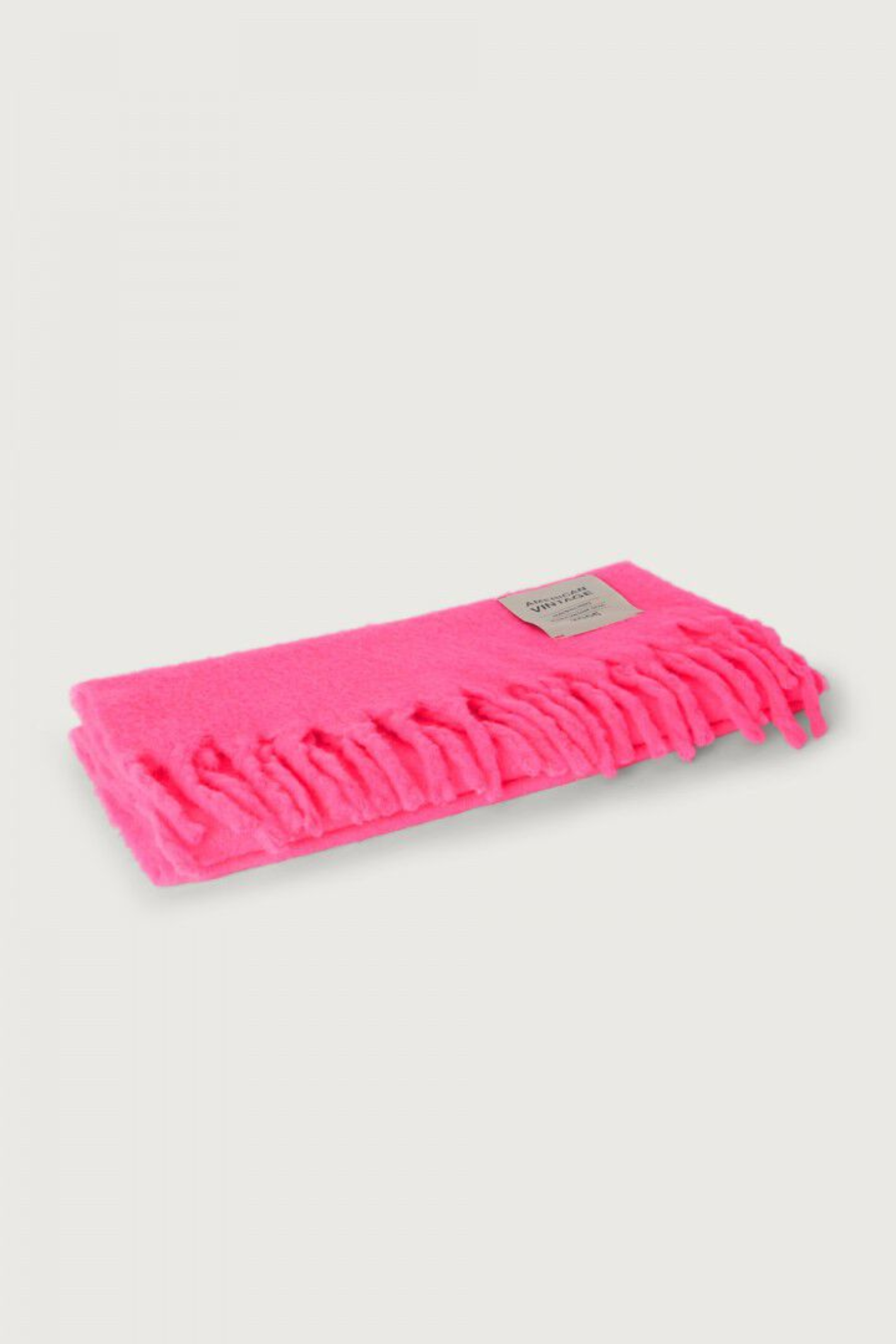 Shop the American Vintage Zinaco Scarf in Rose Fluo at Dotique. A soft brushed scarf with fringed edges in a vibrant pink shade for effortless everyday styling.