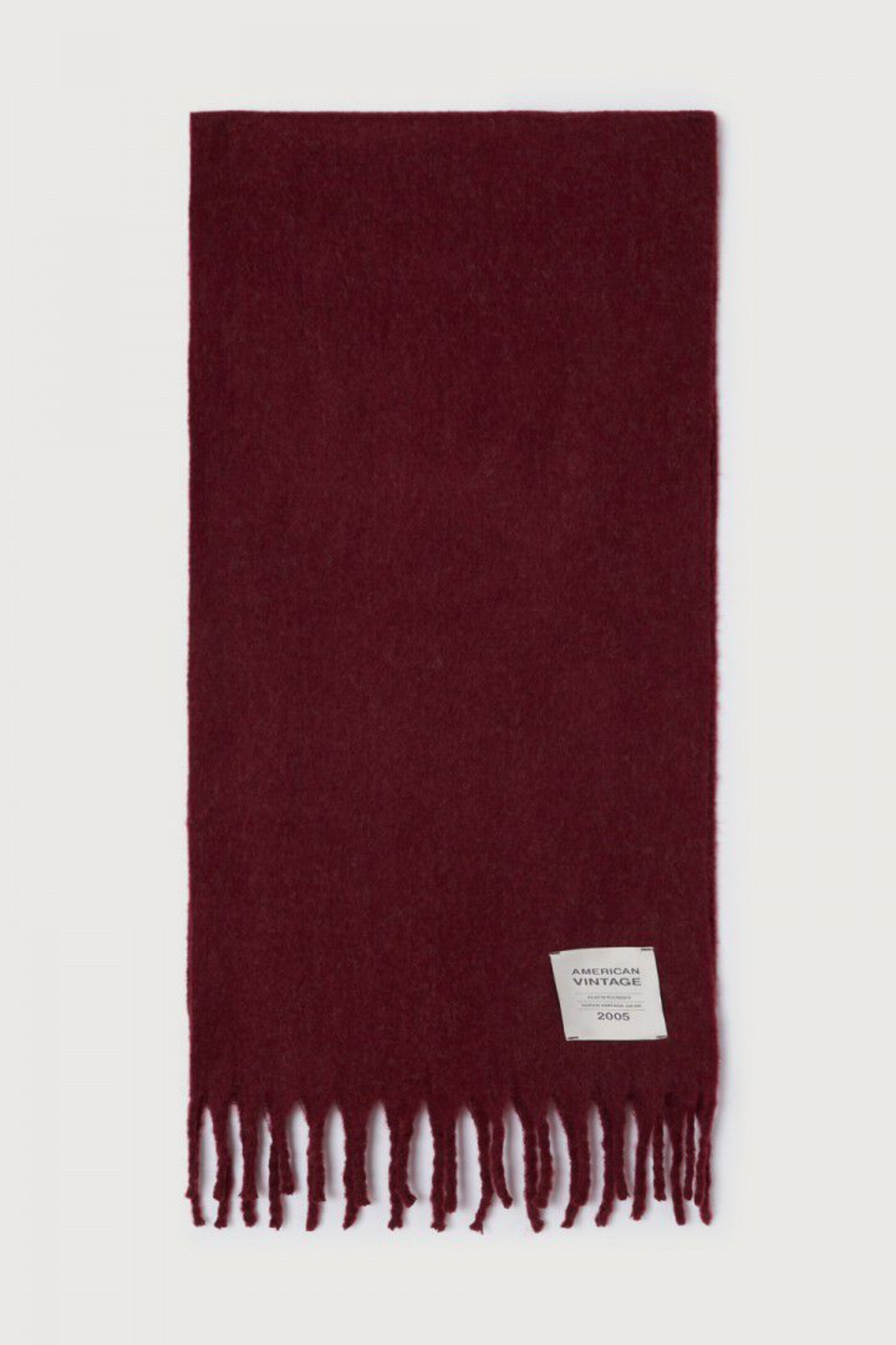 Shop the American Vintage Zinaco Scarf in Cherry Tree Logo at Dotique. A soft brushed scarf with fringed edges in a rich burgundy shade for effortless everyday styling.