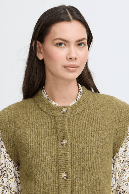 Atelier Rêve Irsilvi Waistcoat, crafted in a cosy moss melange green knit. Available at Dotique Witney