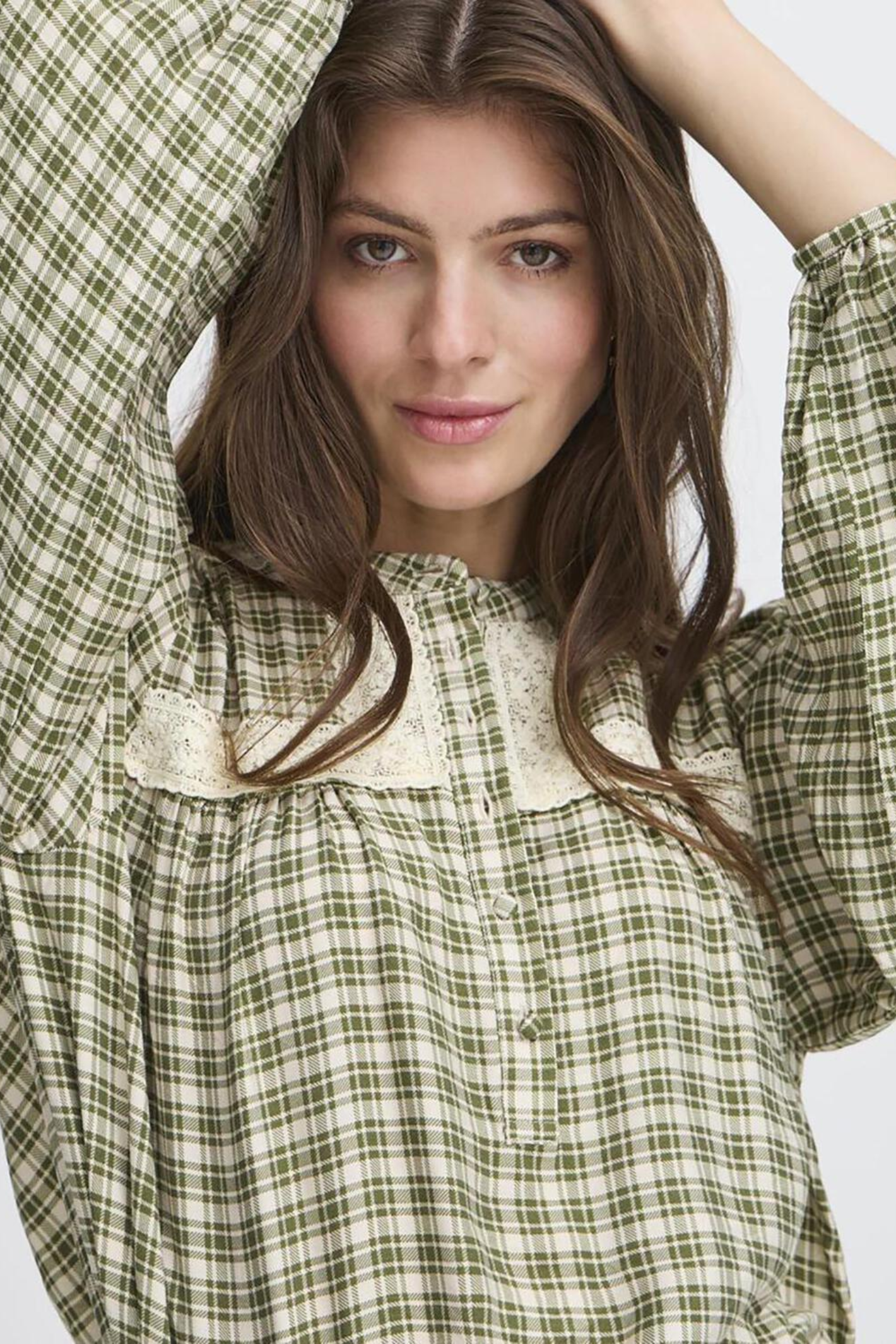 Atelier Rêve IR Tiana blouse in a check capulet olive print. Lightweight and stylish with a relaxed fit, perfect for everyday wear. Shop at Dotique.
