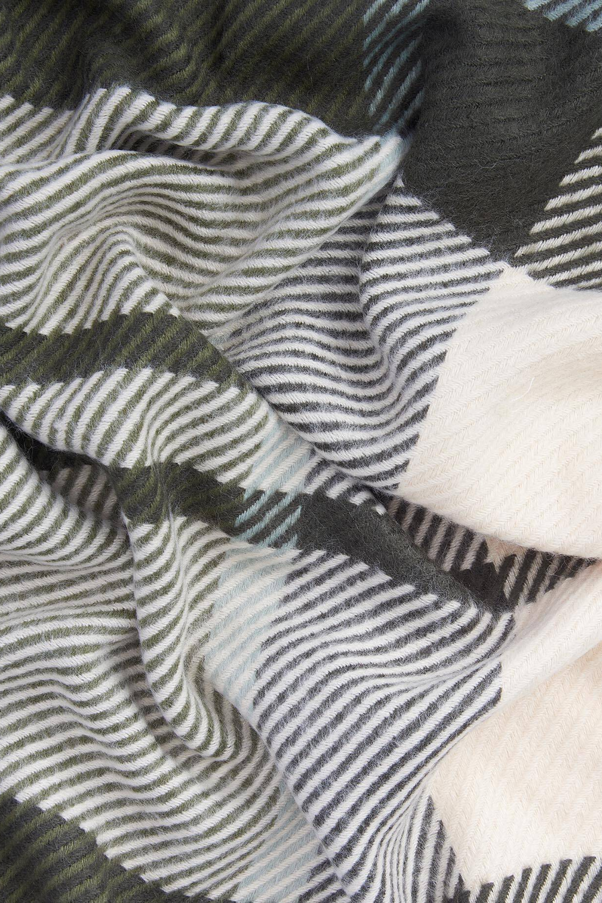 Black and white woven fabric with wavy striped patterns and soft textured folds