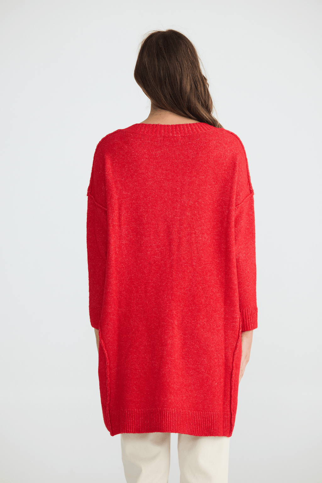 Person wearing a red sweater on a white background