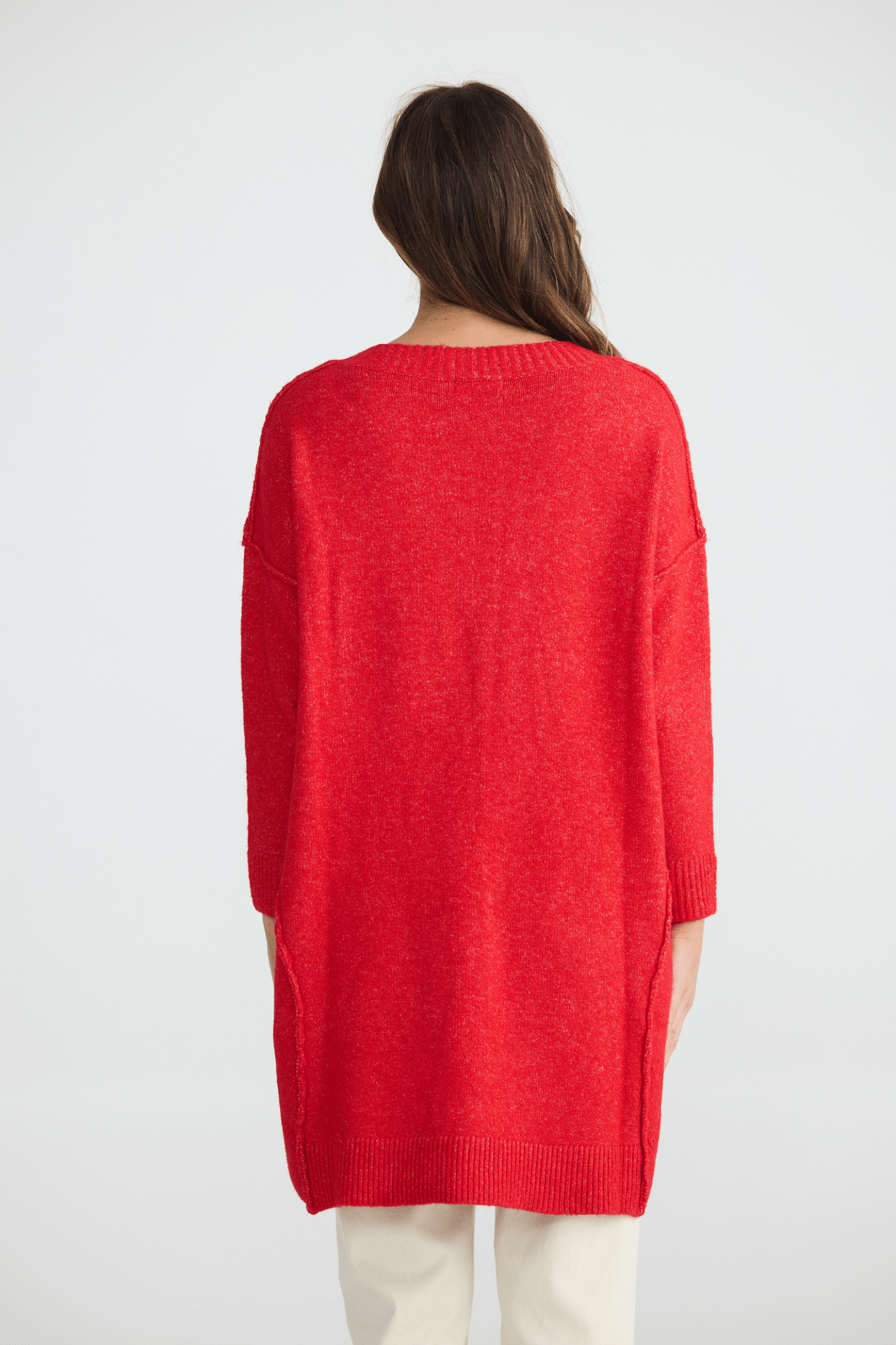 Person wearing a red sweater on a white background