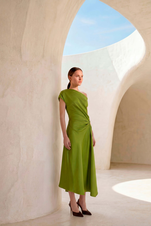 Model wearing the Carla Ruiz 53035 Midi Dress Lima in green with one-shoulder design, paired with dark heels, shop Carla Ruiz at Dotique.