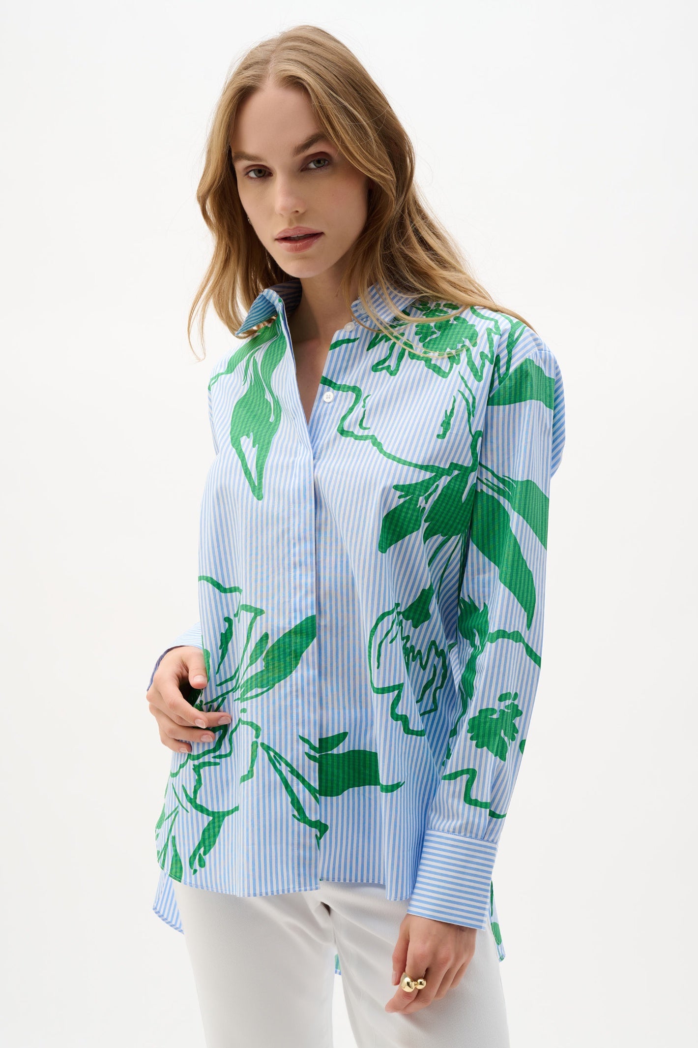 Model wearing Joseph Ribkoff Cotton Stripe Floral Print Boxy Blouse 262951 with blue and white stripes and green floral design by Joseph Ribkoff, shop Joseph Ribkoff at Dotique.