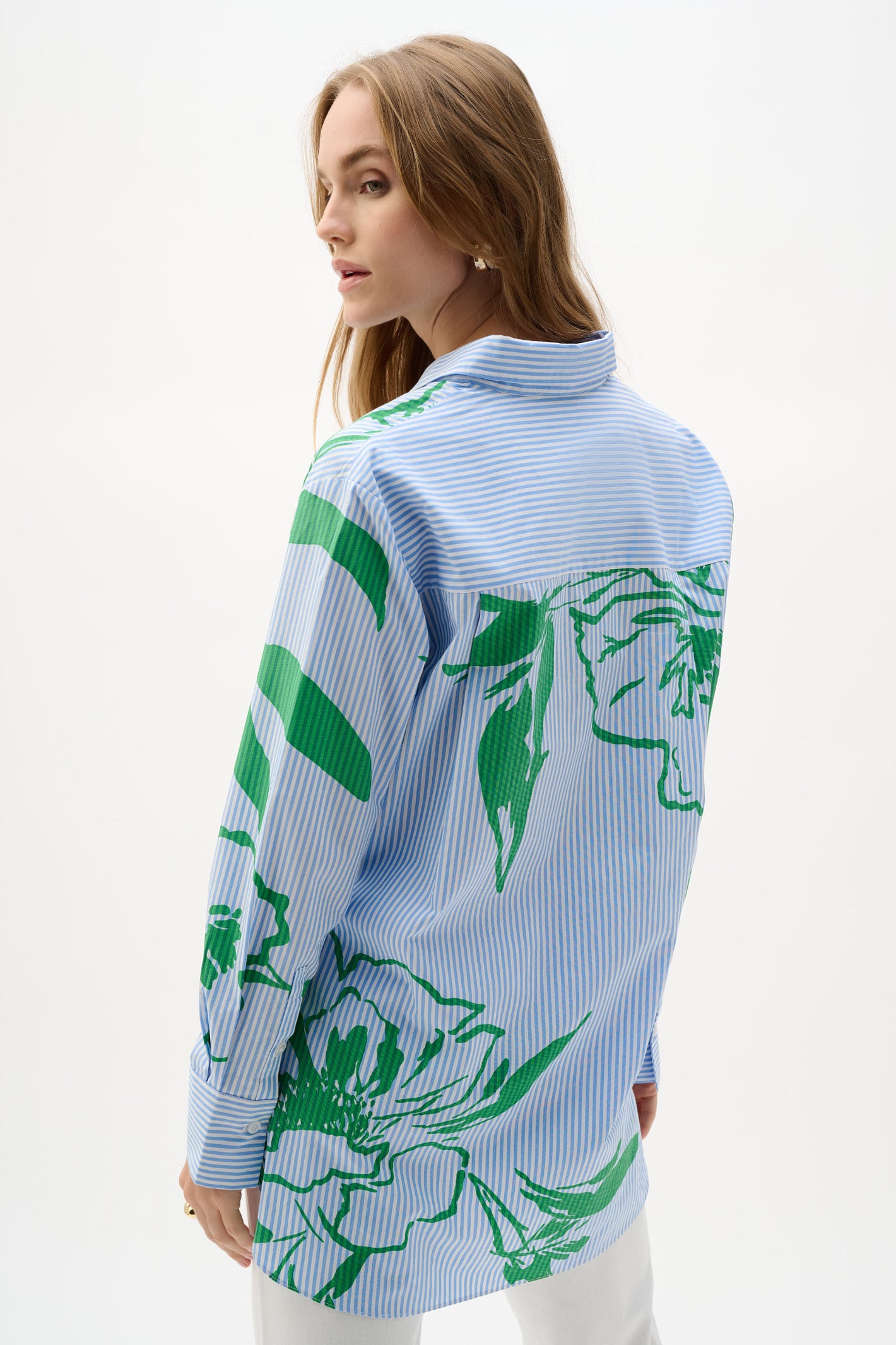 Model wearing Joseph Ribkoff Cotton Stripe Floral Print Boxy Blouse 262951 with blue stripes and green floral design by Joseph Ribkoff, shop Joseph Ribkoff at Dotique.