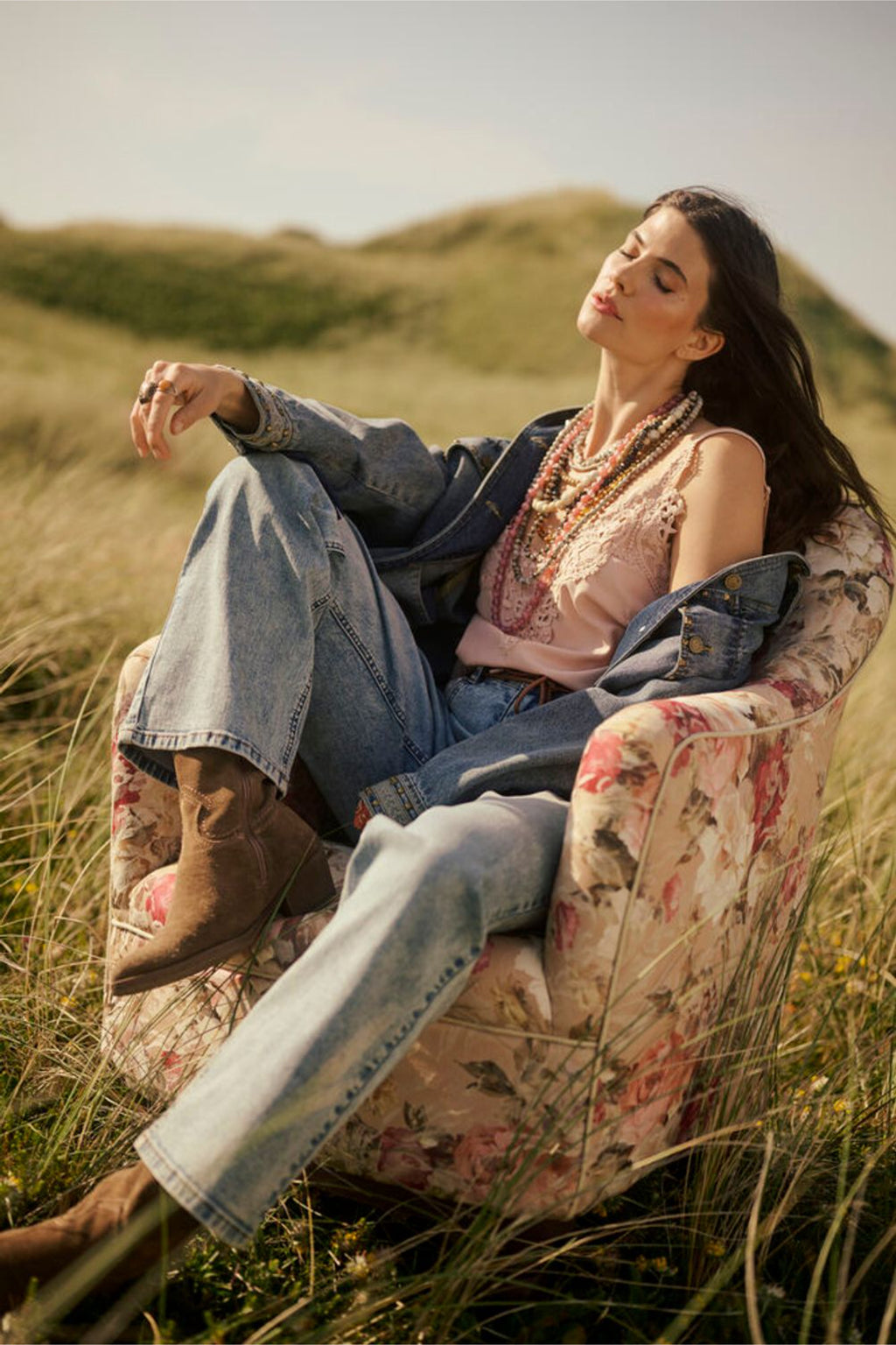 Model relaxing outdoors wearing Cream 10611224 CRanna Peach Blush Lace Vest Top by Cream, shop the vendor at Dotique