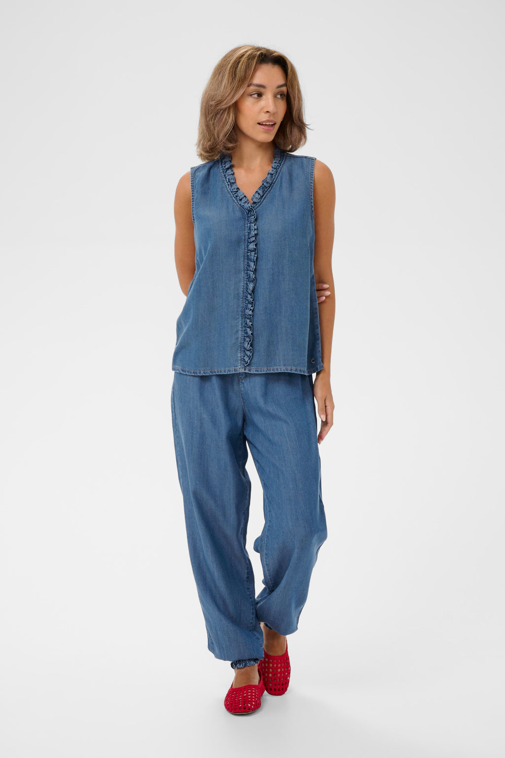 Model wearing Cream CRMolly Sleeveless Blouse Jaspar Blue Denim 10614943 by Cream, shop the vendor at Dotique