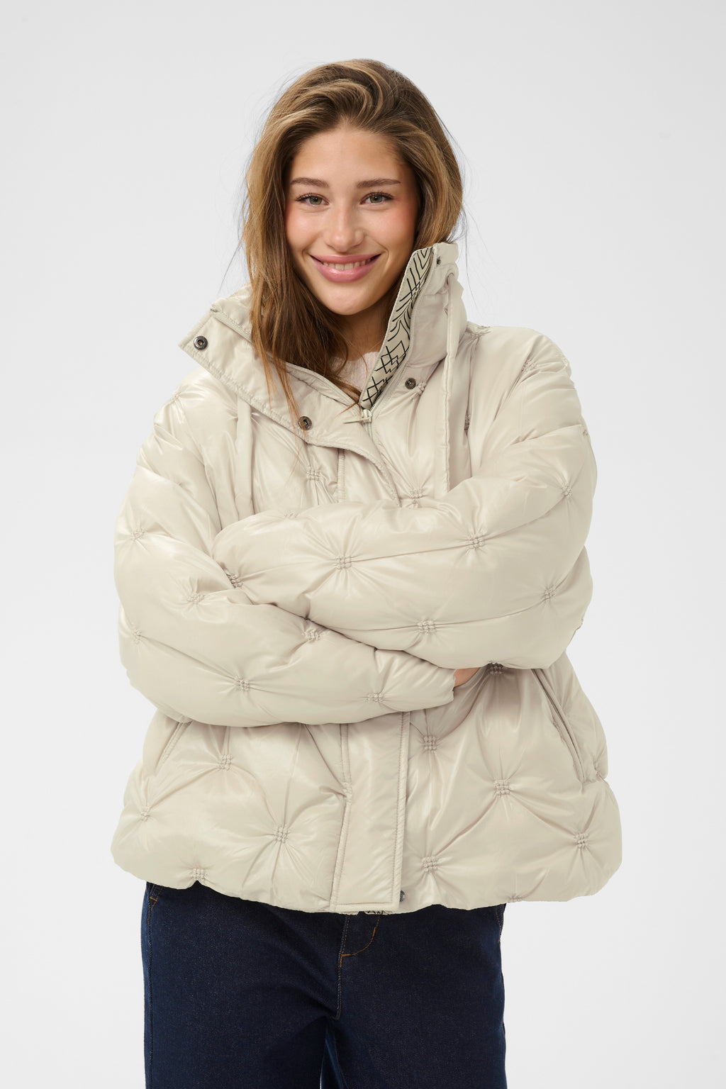 Cream CRDrakie quilted short jacket in Oatmeal featuring a gathered quilted design, hood, high collar and zip fastening.