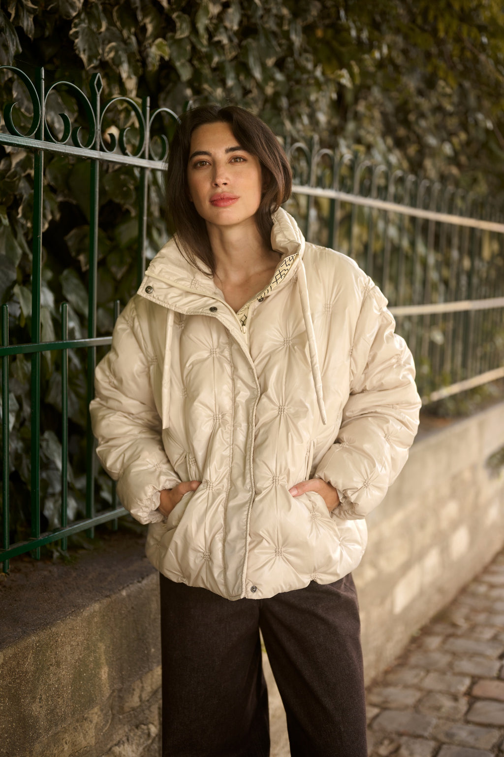 Cream CRDrakie quilted short jacket in Oatmeal featuring a gathered quilted design, hood, high collar and zip fastening.