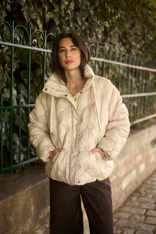 Cream CRDrakie quilted short jacket in Oatmeal featuring a gathered quilted design, hood, high collar and zip fastening.